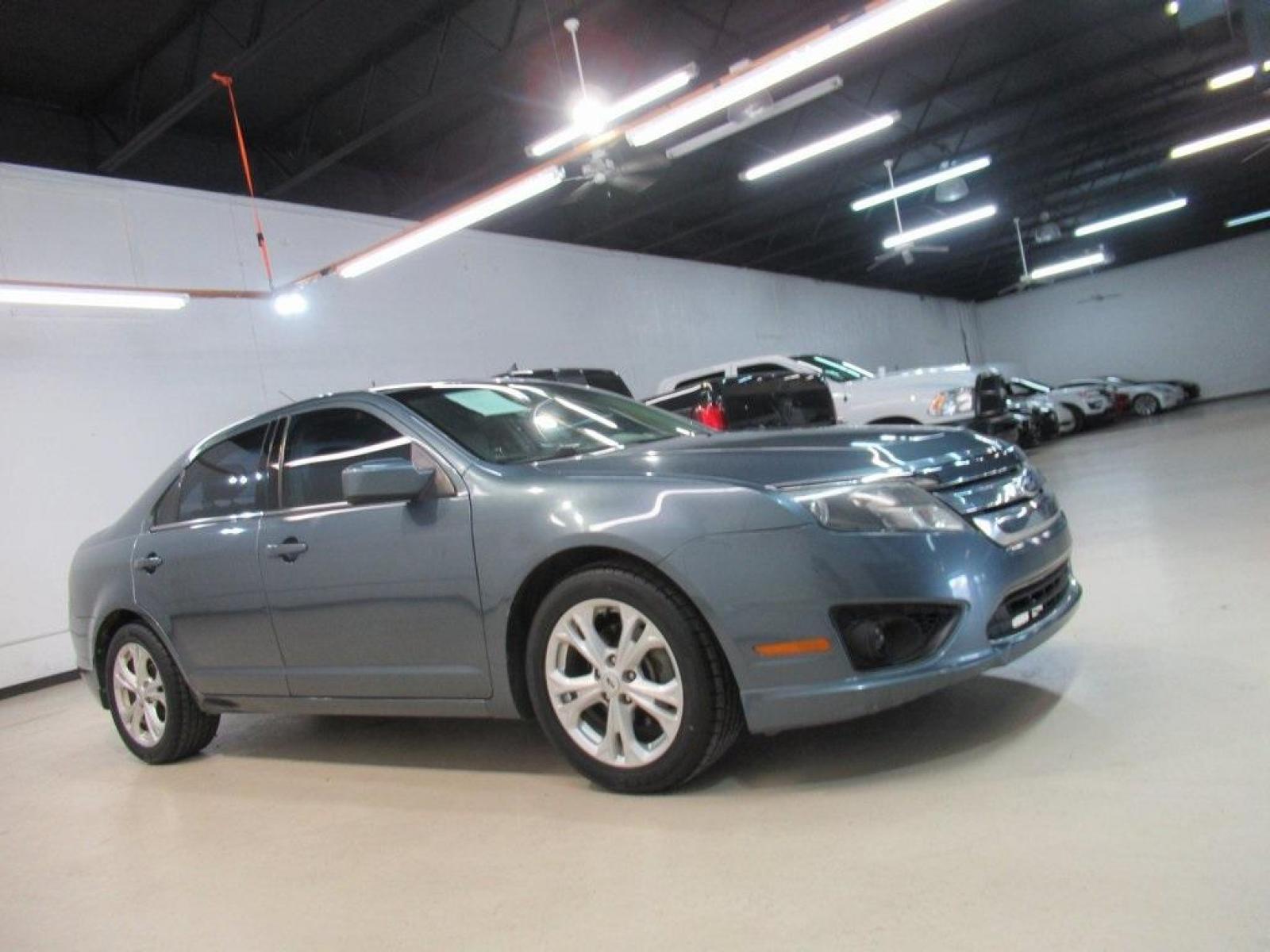 2012 Blue Flame Metallic /Camel Ford Fusion SE (3FAHP0HA5CR) with an 2.5L I4 engine, Automatic transmission, located at 15300 Midway Rd., Addison, 75001, (972) 702-0011, 32.958321, -96.838074 - HOME OF THE NO HAGGLE PRICE - WHOLESALE PRICES TO THE PUBLIC!! Fusion SE, 4D Sedan, 2.5L I4, 6-Speed Automatic, FWD, Blue Flame Metallic, Camel Cloth. Priced below KBB Fair Purchase Price!<br><br>Blue Flame Metallic 2012 Ford Fusion SE<br><br>23/33 City/Highway MPG<br><br>Awards:<br> * 2012 IIHS To - Photo #6