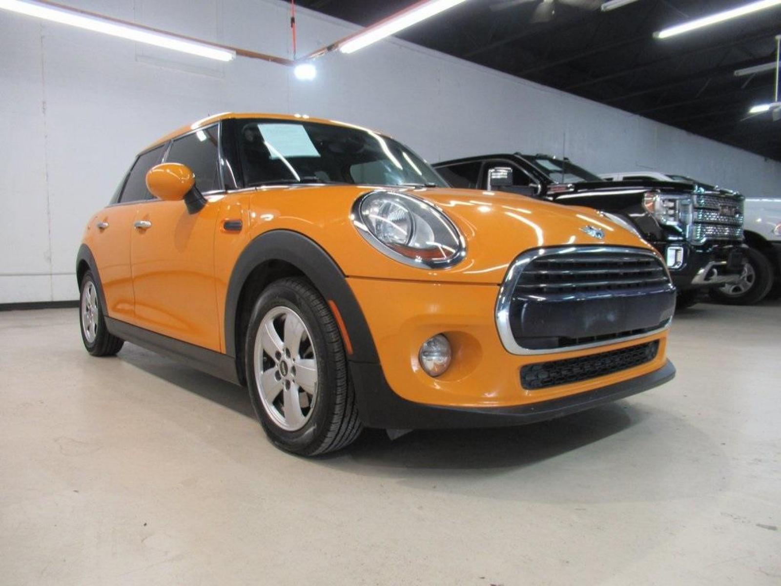 2016 Volcanic Orange /Carbon Black MINI Cooper Base (WMWXU1C51G2) with an 1.5L 12V TwinPower Turbo engine, Automatic transmission, located at 15300 Midway Rd., Addison, 75001, (972) 702-0011, 32.958321, -96.838074 - HOME OF THE NO HAGGLE PRICE - WHOLESALE PRICES TO THE PUBLIC!! 4D Hatchback, 1.5L 12V TwinPower Turbo, 6-Speed Automatic, FWD, Volcanic Orange, Carbon Black Artificial Leather. Odometer is 9768 miles below market average!<br><br>Volcanic Orange 2016 MINI Cooper<br><br>Recent Arrival! 27/37 City/High - Photo #1