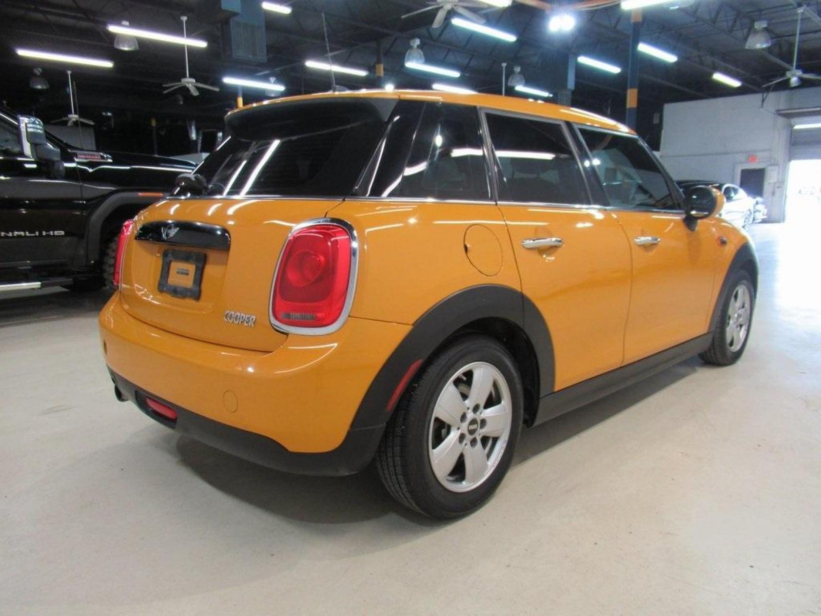 2016 Volcanic Orange /Carbon Black MINI Cooper Base (WMWXU1C51G2) with an 1.5L 12V TwinPower Turbo engine, Automatic transmission, located at 15300 Midway Rd., Addison, 75001, (972) 702-0011, 32.958321, -96.838074 - HOME OF THE NO HAGGLE PRICE - WHOLESALE PRICES TO THE PUBLIC!! 4D Hatchback, 1.5L 12V TwinPower Turbo, 6-Speed Automatic, FWD, Volcanic Orange, Carbon Black Artificial Leather. Odometer is 9768 miles below market average!<br><br>Volcanic Orange 2016 MINI Cooper<br><br>Recent Arrival! 27/37 City/High - Photo #2