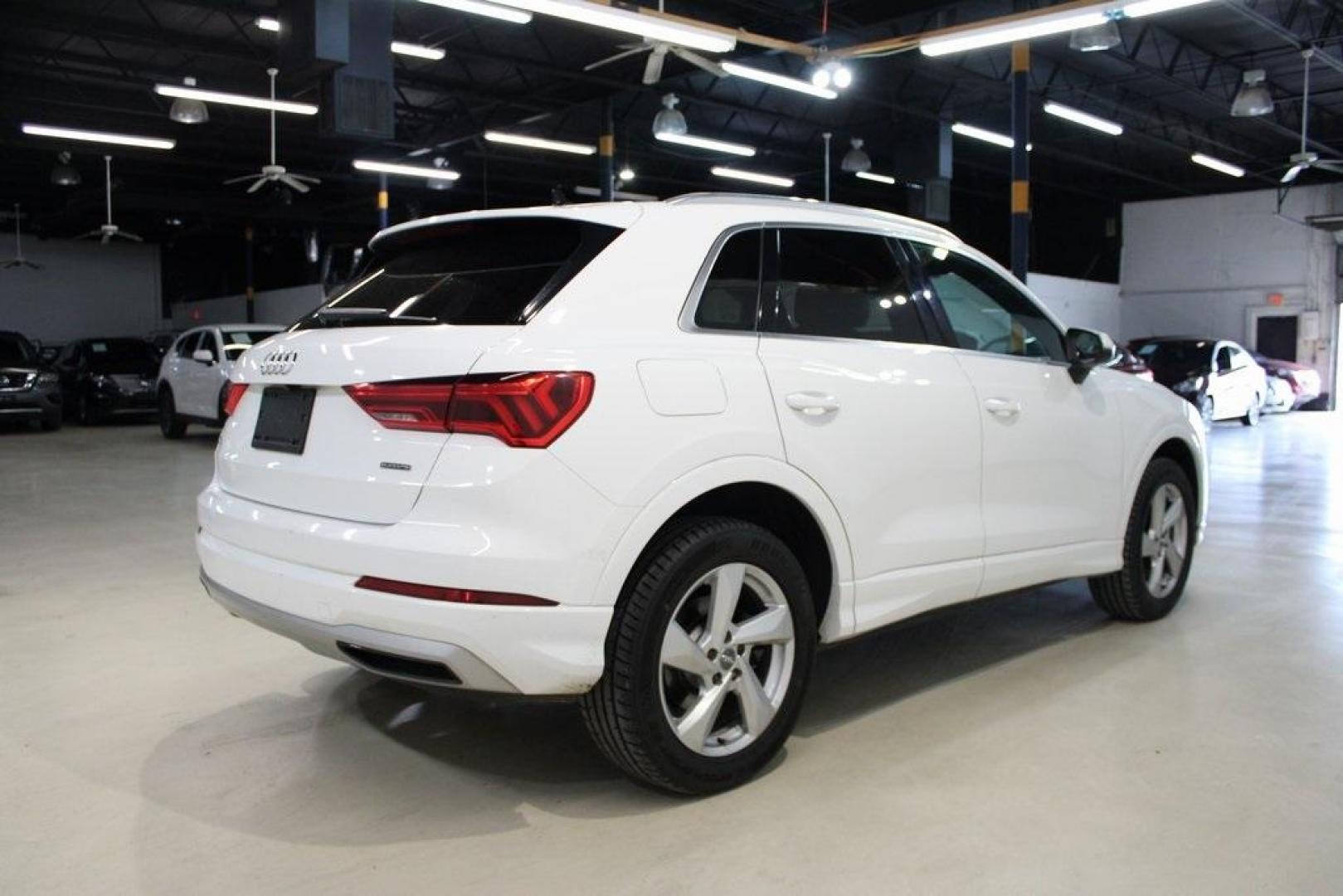 2020 White /Black Audi Q3 Premium (WA1AECF34L1) with an 2.0L 4-Cylinder TFSI engine, Automatic transmission, located at 15300 Midway Rd., Addison, TX, 75001, (972) 702-0011, 32.958321, -96.838074 - HOME OF THE NO HAGGLE PRICE - WHOLESALE PRICES TO THE PUBLIC!! Q3 Premium quattro, 4D Sport Utility, 2.0L 4-Cylinder TFSI, 8-Speed Automatic with Tiptronic, quattro, White, Leather.<br><br>White 2020 Audi Q3 Premium<br><br>19/27 City/Highway MPG<br><br>Awards:<br> * 2020 KBB.com Best Buy Awards<br> - Photo#2