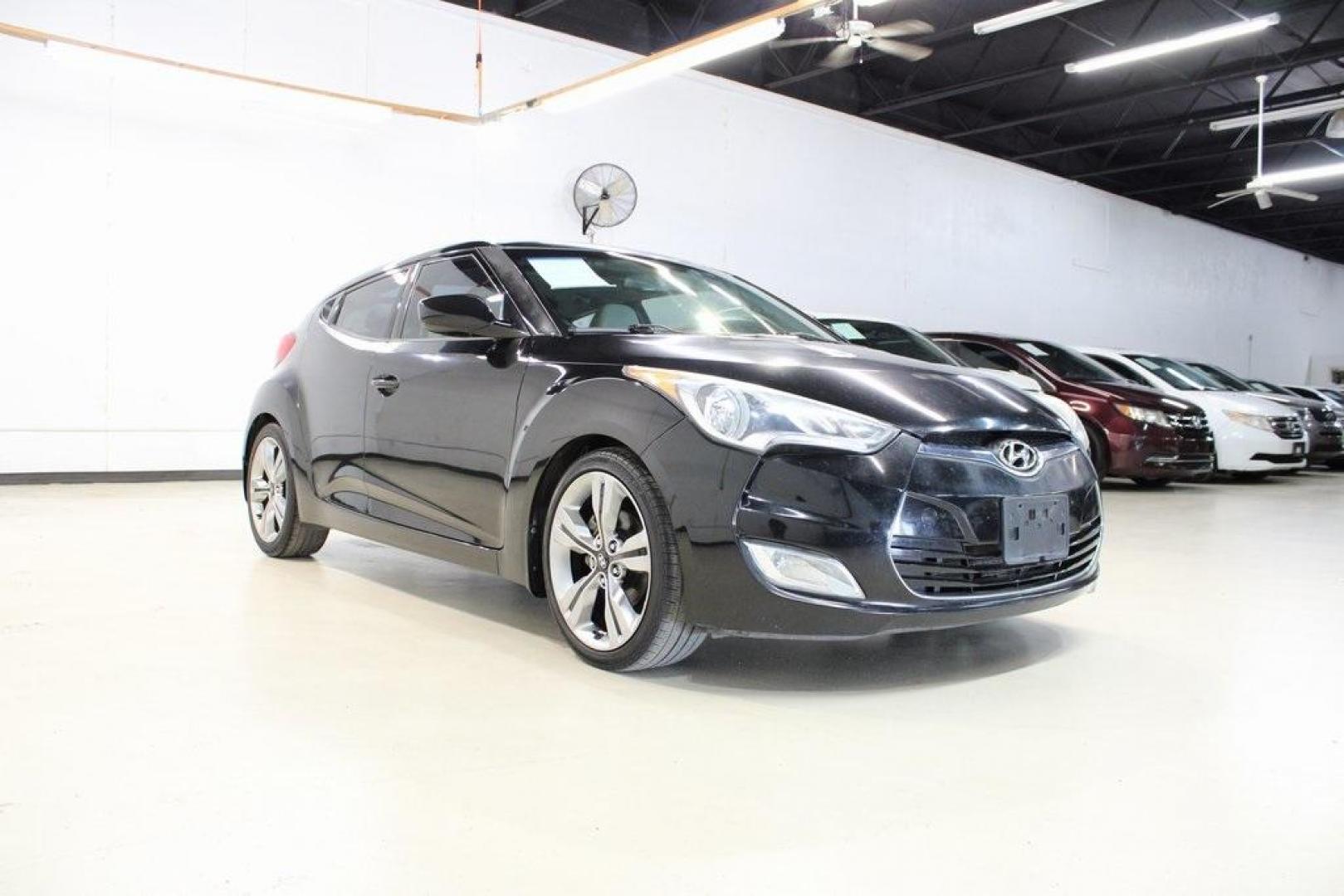 2012 Ultra Black /Gray Hyundai Veloster Base (KMHTC6ADXCU) with an 1.6L 4-Cylinder DGI DOHC engine, Automatic transmission, located at 15300 Midway Rd., Addison, TX, 75001, (972) 702-0011, 32.958321, -96.838074 - Introducing the 2012 Hyundai Veloster, now available at Midway Auto Group in Addison, Texas. This innovative hatchback combines sporty design, advanced technology, and impressive fuel efficiency, making it an excellent choice for drivers seeking both style and practicality.<br><br>Key Features:<br>< - Photo#1