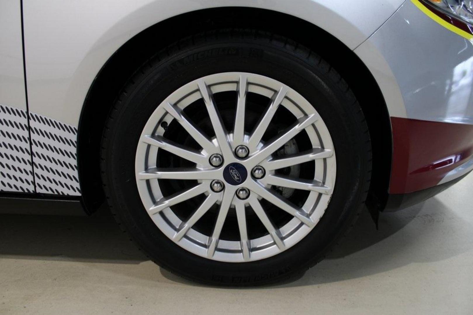 2014 Ingot Silver /Medium Light Stone Ford Focus Electric Base (1FADP3R42EL) with an 107kW Electric Motor engine, Automatic transmission, located at 15300 Midway Rd., Addison, TX, 75001, (972) 702-0011, 32.958321, -96.838074 - Introducing the 2014 Ford Focus Electric, now available at Midway Auto Group in Addison, Texas. This eco-friendly hatchback combines zero-emission performance with modern features, making it an excellent choice for environmentally conscious drivers seeking efficiency without compromising on style.<b - Photo#11