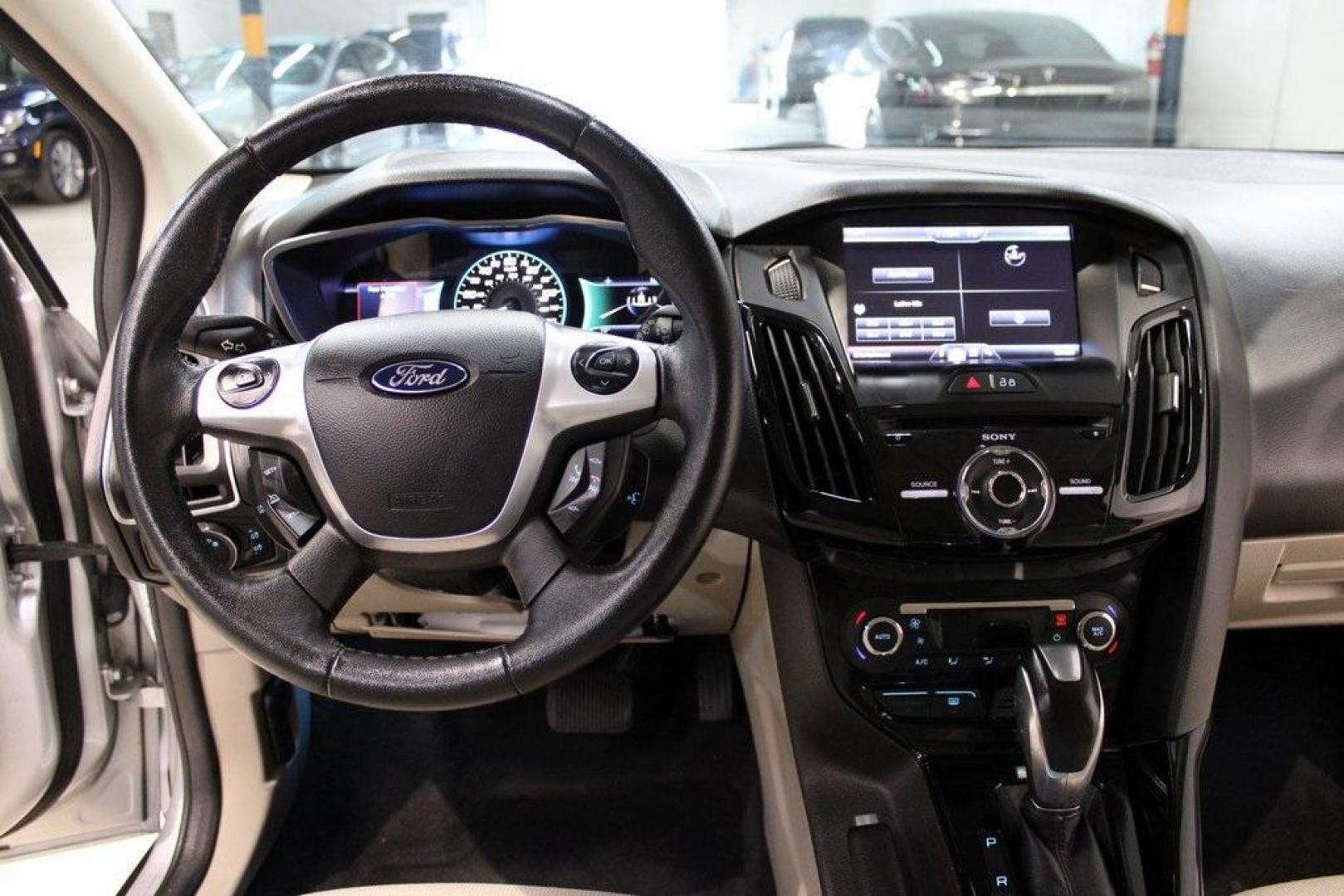 2014 Ingot Silver /Medium Light Stone Ford Focus Electric Base (1FADP3R42EL) with an 107kW Electric Motor engine, Automatic transmission, located at 15300 Midway Rd., Addison, TX, 75001, (972) 702-0011, 32.958321, -96.838074 - Introducing the 2014 Ford Focus Electric, now available at Midway Auto Group in Addison, Texas. This eco-friendly hatchback combines zero-emission performance with modern features, making it an excellent choice for environmentally conscious drivers seeking efficiency without compromising on style.<b - Photo#16