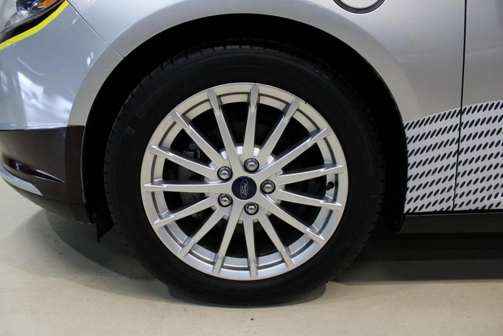 2014 Ingot Silver /Medium Light Stone Ford Focus Electric Base (1FADP3R42EL) with an 107kW Electric Motor engine, Automatic transmission, located at 15300 Midway Rd., Addison, TX, 75001, (972) 702-0011, 32.958321, -96.838074 - Introducing the 2014 Ford Focus Electric, now available at Midway Auto Group in Addison, Texas. This eco-friendly hatchback combines zero-emission performance with modern features, making it an excellent choice for environmentally conscious drivers seeking efficiency without compromising on style.<b - Photo#8