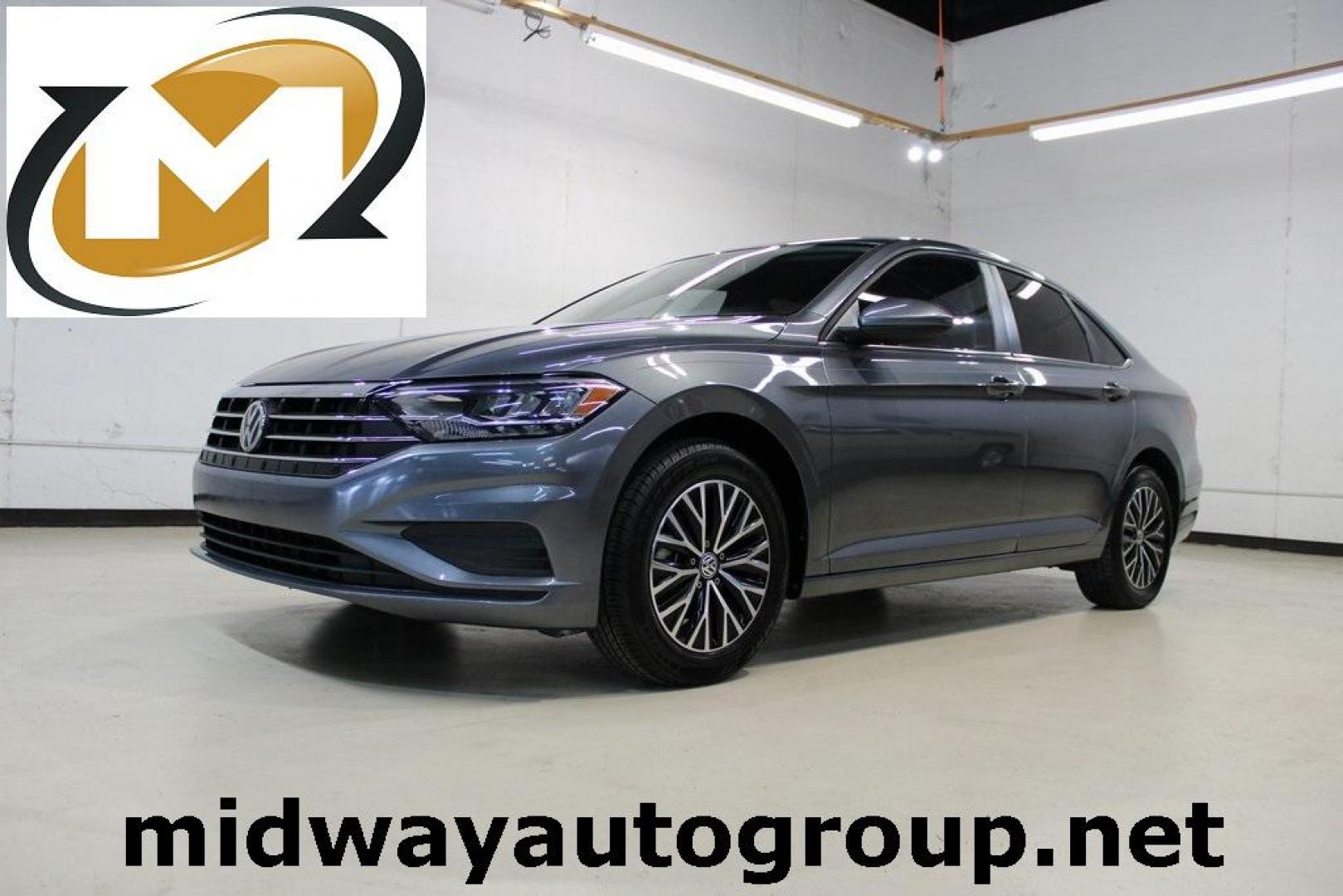 2021 Pyrite Silver Metallic /Storm Gray Volkswagen Jetta 1.4T S (3VWC57BU6MM) with an 1.4L TSI engine, Automatic transmission, located at 15300 Midway Rd., Addison, TX, 75001, (972) 702-0011, 32.958321, -96.838074 - HOME OF THE NO HAGGLE PRICE - WHOLESALE PRICES TO THE PUBLIC!! Jetta 1.4T S, 4D Sedan, 1.4L TSI, 8-Speed Automatic, FWD.<br><br>Pyrite Silver Metallic 2021 Volkswagen Jetta 1.4T S<br><br>29/39 City/Highway MPG<br><br><br>At Midway Auto Group, we strive to provide you with the best quality vehicles f - Photo#0