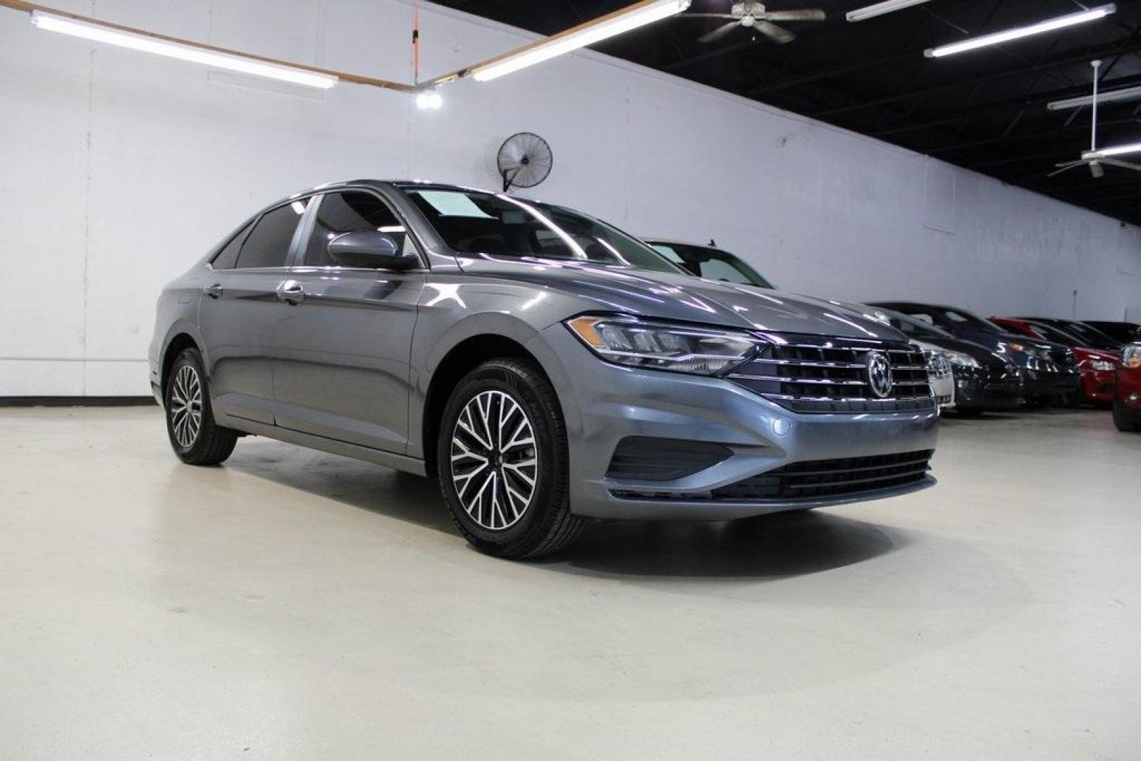2021 Pyrite Silver Metallic /Storm Gray Volkswagen Jetta 1.4T S (3VWC57BU6MM) with an 1.4L TSI engine, Automatic transmission, located at 15300 Midway Rd., Addison, TX, 75001, (972) 702-0011, 32.958321, -96.838074 - HOME OF THE NO HAGGLE PRICE - WHOLESALE PRICES TO THE PUBLIC!! Jetta 1.4T S, 4D Sedan, 1.4L TSI, 8-Speed Automatic, FWD.<br><br>Pyrite Silver Metallic 2021 Volkswagen Jetta 1.4T S<br><br>29/39 City/Highway MPG<br><br><br>At Midway Auto Group, we strive to provide you with the best quality vehicles f - Photo#1
