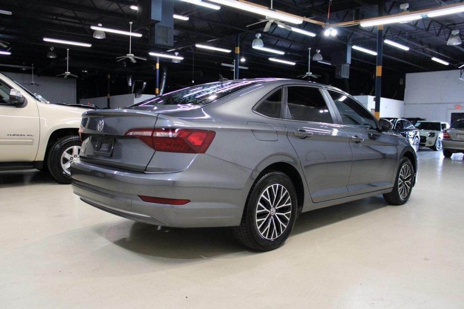 2021 Pyrite Silver Metallic /Storm Gray Volkswagen Jetta 1.4T S (3VWC57BU6MM) with an 1.4L TSI engine, Automatic transmission, located at 15300 Midway Rd., Addison, TX, 75001, (972) 702-0011, 32.958321, -96.838074 - HOME OF THE NO HAGGLE PRICE - WHOLESALE PRICES TO THE PUBLIC!! Jetta 1.4T S, 4D Sedan, 1.4L TSI, 8-Speed Automatic, FWD.<br><br>Pyrite Silver Metallic 2021 Volkswagen Jetta 1.4T S<br><br>29/39 City/Highway MPG<br><br><br>At Midway Auto Group, we strive to provide you with the best quality vehicles f - Photo#2