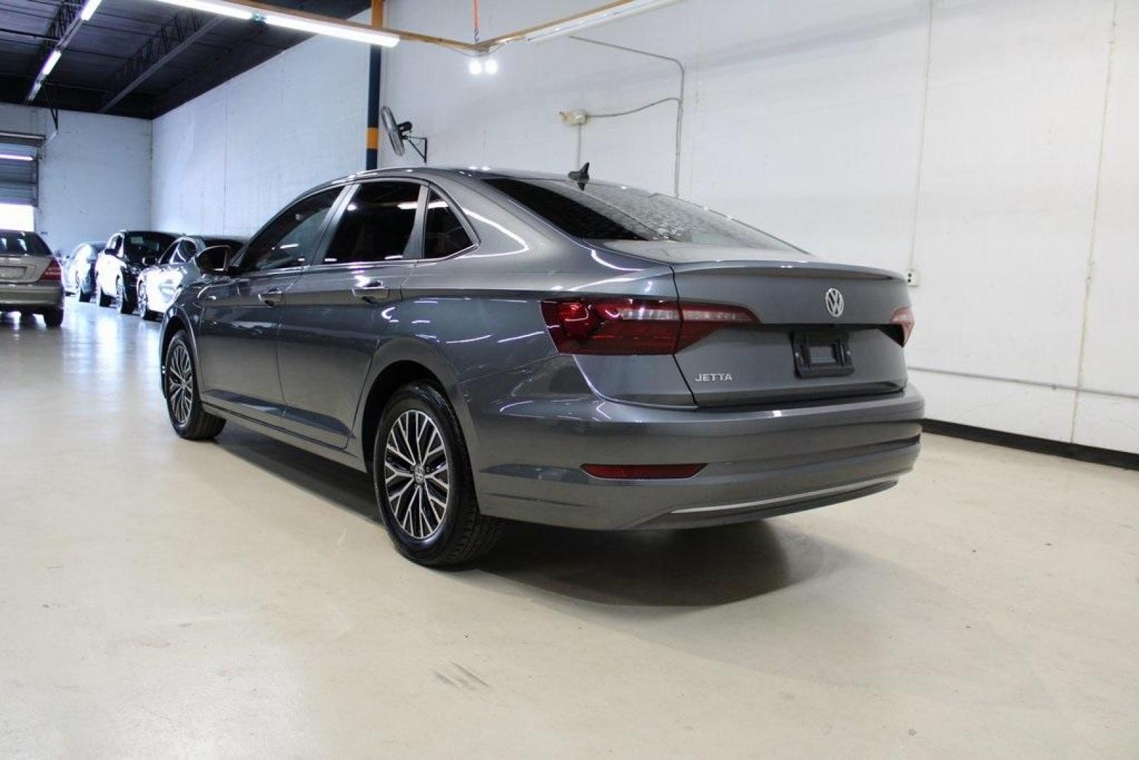 2021 Pyrite Silver Metallic /Storm Gray Volkswagen Jetta 1.4T S (3VWC57BU6MM) with an 1.4L TSI engine, Automatic transmission, located at 15300 Midway Rd., Addison, TX, 75001, (972) 702-0011, 32.958321, -96.838074 - HOME OF THE NO HAGGLE PRICE - WHOLESALE PRICES TO THE PUBLIC!! Jetta 1.4T S, 4D Sedan, 1.4L TSI, 8-Speed Automatic, FWD.<br><br>Pyrite Silver Metallic 2021 Volkswagen Jetta 1.4T S<br><br>29/39 City/Highway MPG<br><br><br>At Midway Auto Group, we strive to provide you with the best quality vehicles f - Photo#3