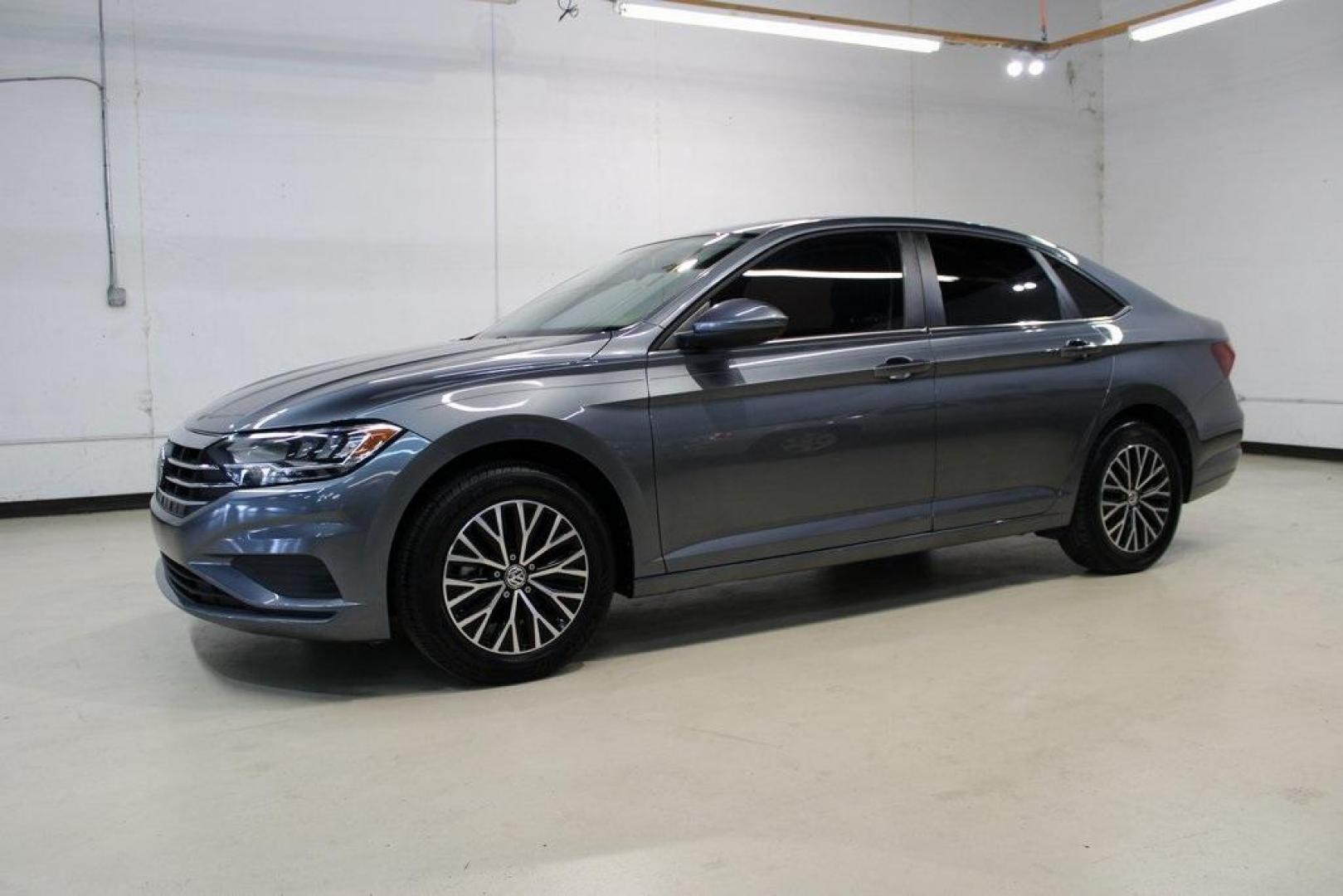 2021 Pyrite Silver Metallic /Storm Gray Volkswagen Jetta 1.4T S (3VWC57BU6MM) with an 1.4L TSI engine, Automatic transmission, located at 15300 Midway Rd., Addison, TX, 75001, (972) 702-0011, 32.958321, -96.838074 - HOME OF THE NO HAGGLE PRICE - WHOLESALE PRICES TO THE PUBLIC!! Jetta 1.4T S, 4D Sedan, 1.4L TSI, 8-Speed Automatic, FWD.<br><br>Pyrite Silver Metallic 2021 Volkswagen Jetta 1.4T S<br><br>29/39 City/Highway MPG<br><br><br>At Midway Auto Group, we strive to provide you with the best quality vehicles f - Photo#4