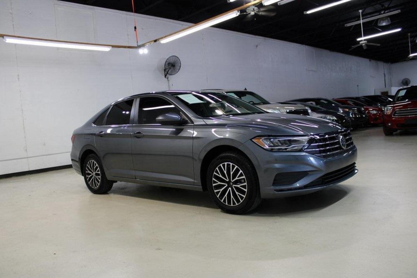 2021 Pyrite Silver Metallic /Storm Gray Volkswagen Jetta 1.4T S (3VWC57BU6MM) with an 1.4L TSI engine, Automatic transmission, located at 15300 Midway Rd., Addison, TX, 75001, (972) 702-0011, 32.958321, -96.838074 - HOME OF THE NO HAGGLE PRICE - WHOLESALE PRICES TO THE PUBLIC!! Jetta 1.4T S, 4D Sedan, 1.4L TSI, 8-Speed Automatic, FWD.<br><br>Pyrite Silver Metallic 2021 Volkswagen Jetta 1.4T S<br><br>29/39 City/Highway MPG<br><br><br>At Midway Auto Group, we strive to provide you with the best quality vehicles f - Photo#6