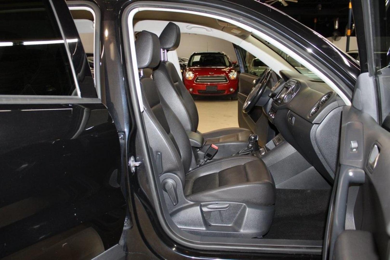 2017 Deep Black /Charcoal Black Volkswagen Tiguan 2.0T S (WVGAV7AX3HK) with an 2.0L TSI DOHC engine, Automatic transmission, located at 15300 Midway Rd., Addison, TX, 75001, (972) 702-0011, 32.958321, -96.838074 - HOME OF THE NO HAGGLE PRICE - WHOLESALE PRICES TO THE PUBLIC!! Tiguan 2.0T S, 4D Sport Utility, 2.0L TSI DOHC, 6-Speed Automatic with Tiptronic, FWD, Black, Charcoal Black w/V-Tex Leatherette Seating Surfaces.<br><br>Black 2017 Volkswagen Tiguan 2.0T S<br><br><br>At Midway Auto Group, we strive to p - Photo#14