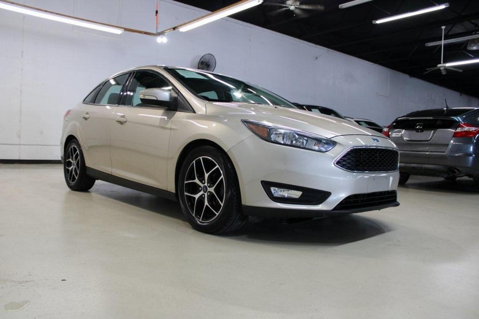 2017 White Gold /Charcoal Black Ford Focus SEL (1FADP3H24HL) with an I4 engine, Automatic transmission, located at 15300 Midway Rd., Addison, TX, 75001, (972) 702-0011, 32.958321, -96.838074 - Photo#1