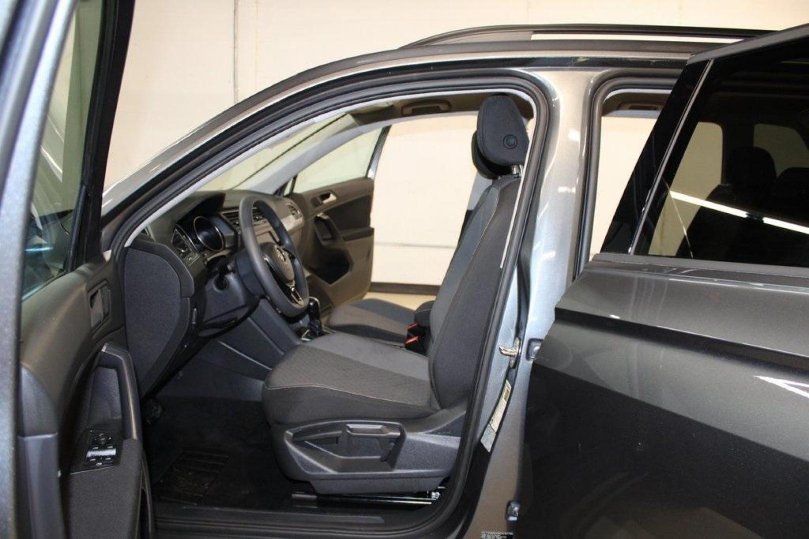 2021 Pyrite Silver Metallic /Storm Gray Volkswagen Tiguan 2.0T S (3VV1B7AX0MM) with an 2.0L TSI DOHC engine, Automatic transmission, located at 15300 Midway Rd., Addison, TX, 75001, (972) 702-0011, 32.958321, -96.838074 - HOME OF THE NO HAGGLE PRICE - WHOLESALE PRICES TO THE PUBLIC!! Tiguan 2.0T S, 4D Sport Utility, 2.0L TSI DOHC, 8-Speed Automatic with Tiptronic, FWD, Storm Gray Cloth.<br><br>Pyrite Silver Metallic 2021 Volkswagen Tiguan 2.0T S<br><br>23/29 City/Highway MPG<br><br><br>At Midway Auto Group, we strive - Photo#14