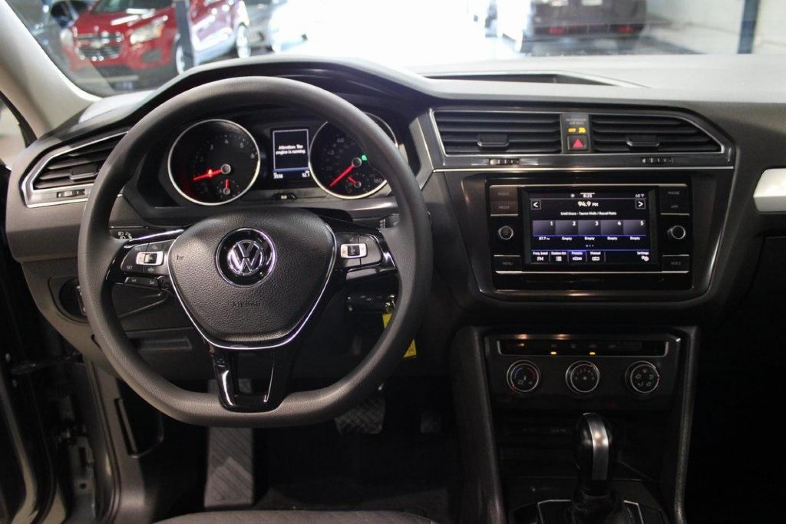 2021 Pyrite Silver Metallic /Storm Gray Volkswagen Tiguan 2.0T S (3VV1B7AX0MM) with an 2.0L TSI DOHC engine, Automatic transmission, located at 15300 Midway Rd., Addison, TX, 75001, (972) 702-0011, 32.958321, -96.838074 - HOME OF THE NO HAGGLE PRICE - WHOLESALE PRICES TO THE PUBLIC!! Tiguan 2.0T S, 4D Sport Utility, 2.0L TSI DOHC, 8-Speed Automatic with Tiptronic, FWD, Storm Gray Cloth.<br><br>Pyrite Silver Metallic 2021 Volkswagen Tiguan 2.0T S<br><br>23/29 City/Highway MPG<br><br><br>At Midway Auto Group, we strive - Photo#19