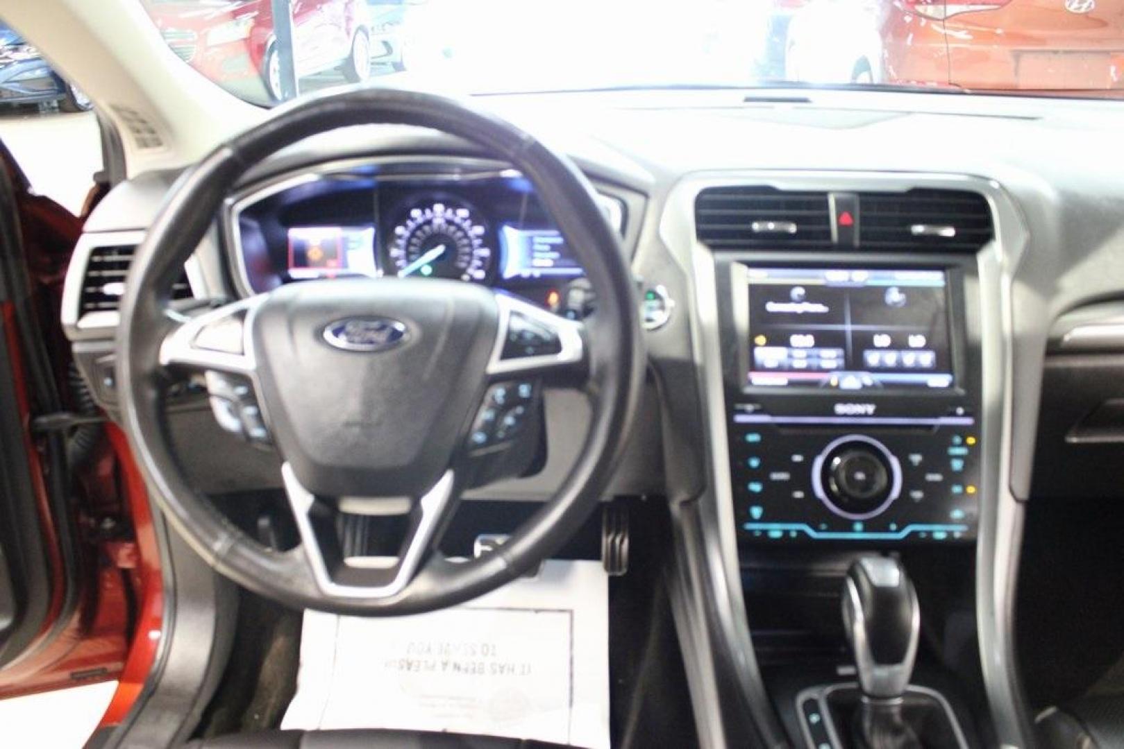 2014 Sunset Metallic /Charcoal Black Ford Fusion Titanium (3FA6P0K97ER) with an EcoBoost 2.0L I4 GTDi DOHC Turbocharged VCT engine, Automatic transmission, located at 15300 Midway Rd., Addison, TX, 75001, (972) 702-0011, 32.958321, -96.838074 - HOME OF THE NO HAGGLE PRICE - WHOLESALE PRICES TO THE PUBLIC!! Fusion Titanium, 4D Sedan, EcoBoost 2.0L I4 GTDi DOHC Turbocharged VCT, 6-Speed Automatic, FWD, Orange, Leather.<br><br>Orange 2014 Ford Fusion Titanium<br><br>22/33 City/Highway MPG<br><br>Awards:<br> * 2014 IIHS Top Safety Pick+ * 2 - Photo#16