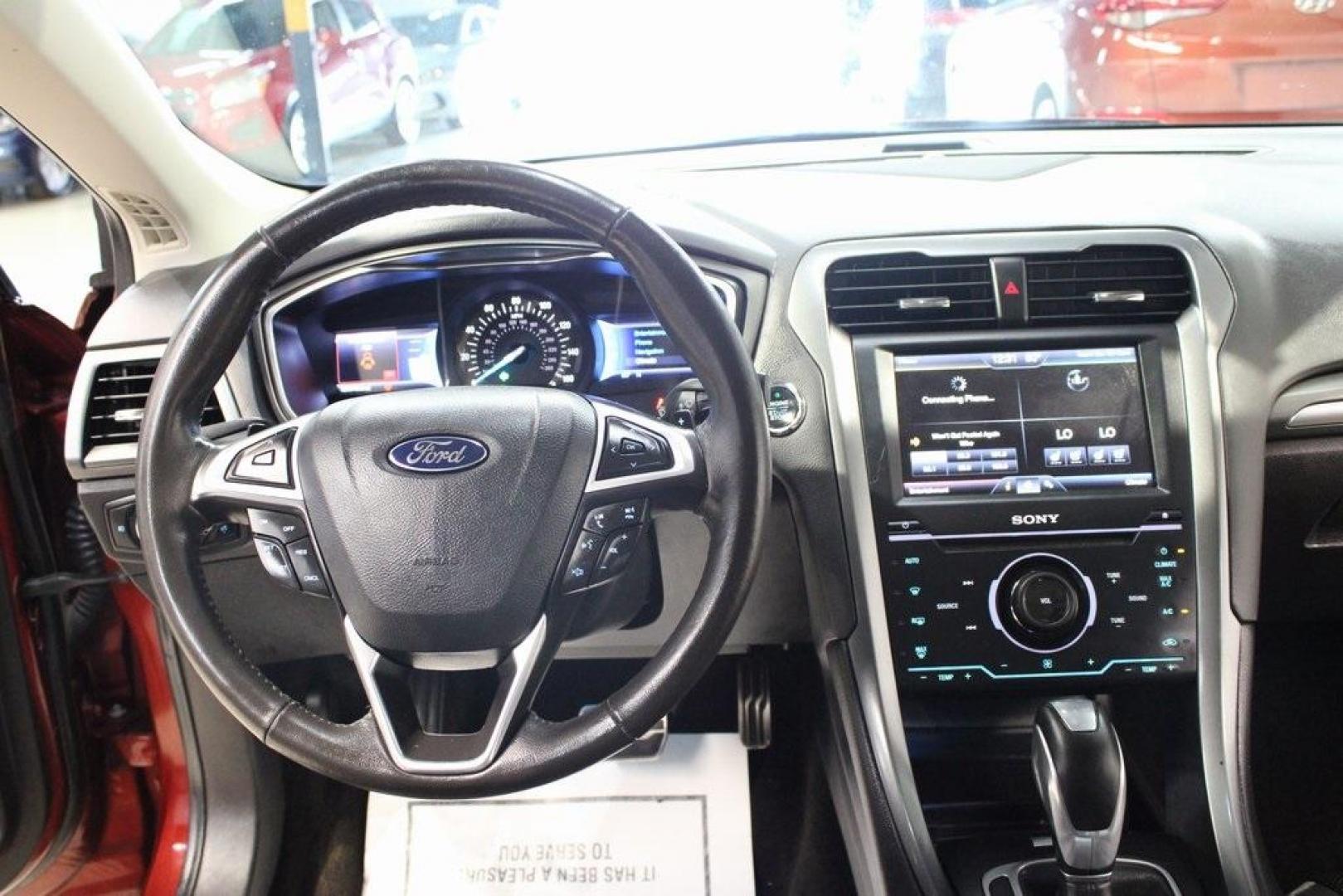 2014 Sunset Metallic /Charcoal Black Ford Fusion Titanium (3FA6P0K97ER) with an EcoBoost 2.0L I4 GTDi DOHC Turbocharged VCT engine, Automatic transmission, located at 15300 Midway Rd., Addison, TX, 75001, (972) 702-0011, 32.958321, -96.838074 - HOME OF THE NO HAGGLE PRICE - WHOLESALE PRICES TO THE PUBLIC!! Fusion Titanium, 4D Sedan, EcoBoost 2.0L I4 GTDi DOHC Turbocharged VCT, 6-Speed Automatic, FWD, Orange, Leather.<br><br>Orange 2014 Ford Fusion Titanium<br><br>22/33 City/Highway MPG<br><br>Awards:<br> * 2014 IIHS Top Safety Pick+ * 2 - Photo#17