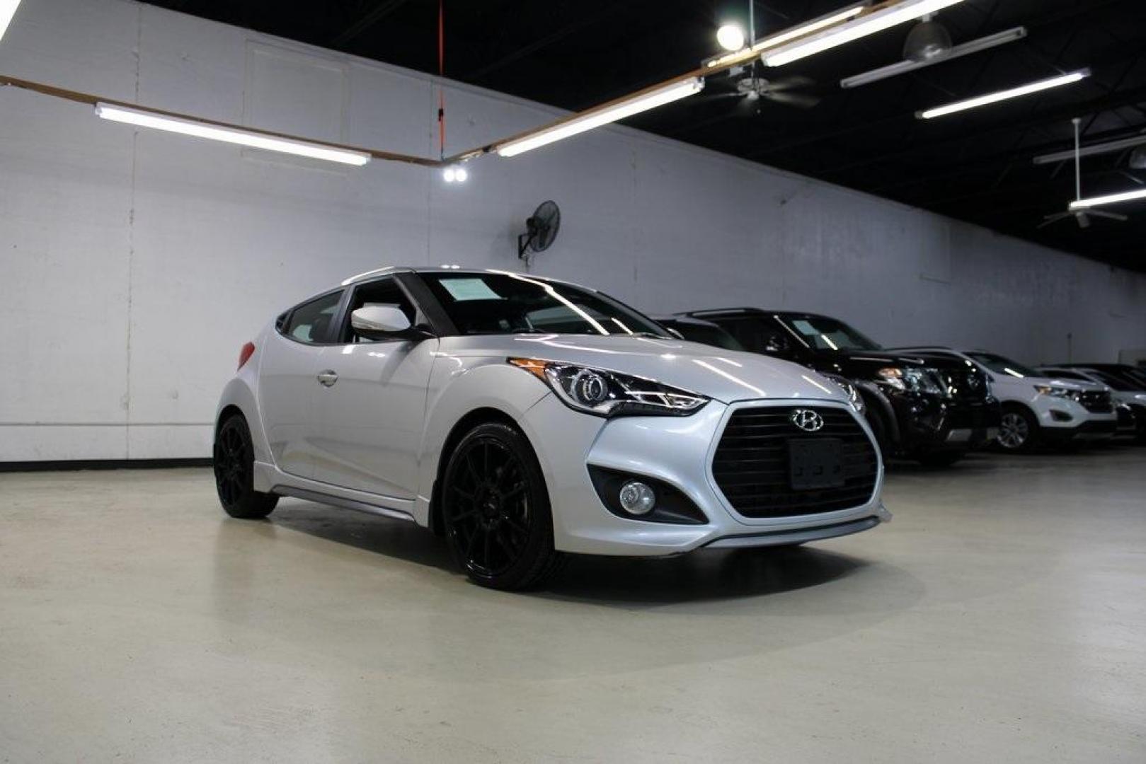 2014 Ironman Silver Metallic /Black Hyundai Veloster Turbo (KMHTC6AEXEU) with an 1.6L I4 DGI DOHC 16V Turbocharged engine, Manual transmission, located at 15300 Midway Rd., Addison, TX, 75001, (972) 702-0011, 32.958321, -96.838074 - Introducing the 2014 Hyundai Veloster Turbo, now available at Midway Auto Group in Addison, Texas. This distinctive hatchback combines sporty performance with innovative design, offering a driving experience that's both exhilarating and practical.<br><br>Key Features:<br><br>Engine: 1.6L Turbocharge - Photo#1