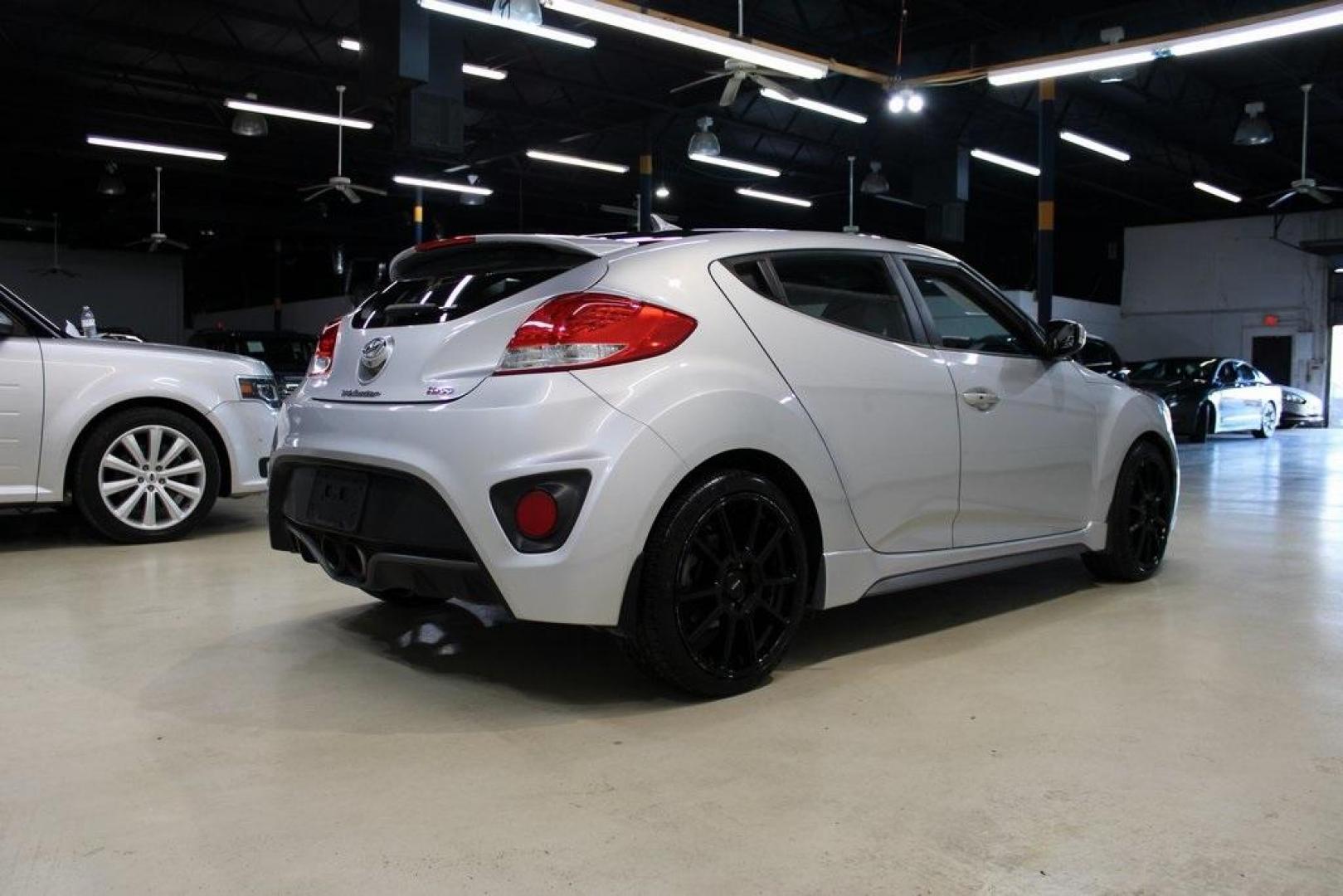 2014 Ironman Silver Metallic /Black Hyundai Veloster Turbo (KMHTC6AEXEU) with an 1.6L I4 DGI DOHC 16V Turbocharged engine, Manual transmission, located at 15300 Midway Rd., Addison, TX, 75001, (972) 702-0011, 32.958321, -96.838074 - Introducing the 2014 Hyundai Veloster Turbo, now available at Midway Auto Group in Addison, Texas. This distinctive hatchback combines sporty performance with innovative design, offering a driving experience that's both exhilarating and practical.<br><br>Key Features:<br><br>Engine: 1.6L Turbocharge - Photo#2