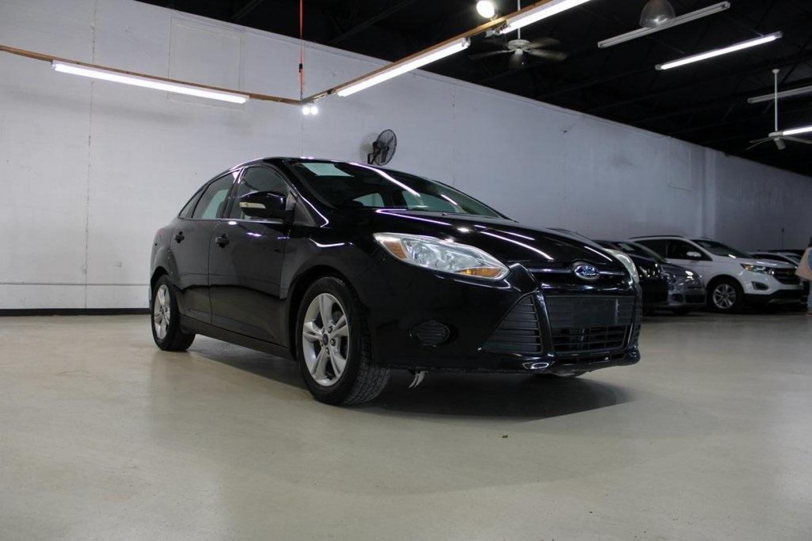 2014 Tuxedo Black Metallic /Black Ford Focus SE (1FADP3F26EL) with an 2.0L 4-Cylinder DGI Flex Fuel DOHC engine, Automatic transmission, located at 15300 Midway Rd., Addison, TX, 75001, (972) 702-0011, 32.958321, -96.838074 - Introducing the 2014 Ford Focus SE, now available at Midway Auto Group in Addison, Texas. This compact sedan offers a harmonious blend of efficiency, comfort, and modern features, making it an excellent choice for daily commutes and city driving.<br><br>Key Features:<br><br>Engine: 2.0L 4-Cylinder<b - Photo#1