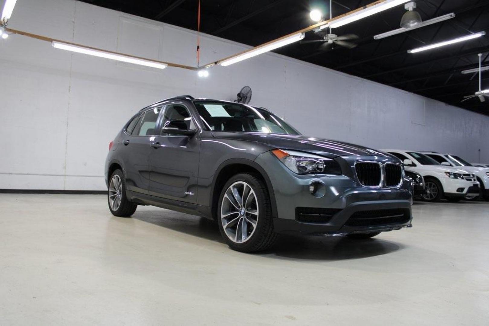 2015 Mineral Grey Metallic /Black BMW X1 xDrive28i (WBAVL1C56FV) with an 2.0L 4-Cylinder DOHC 16V TwinPower Turbo engine, Automatic transmission, located at 15300 Midway Rd., Addison, TX, 75001, (972) 702-0011, 32.958321, -96.838074 - Introducing the 2015 BMW X1 xDrive28i, now available at Midway Auto Group in Addison, Texas. This compact luxury SUV combines BMW's renowned performance with versatility and style, making it an excellent choice for both city driving and weekend adventures.<br><br>Key Features:<br><br>Engine: 2.0-lit - Photo#1
