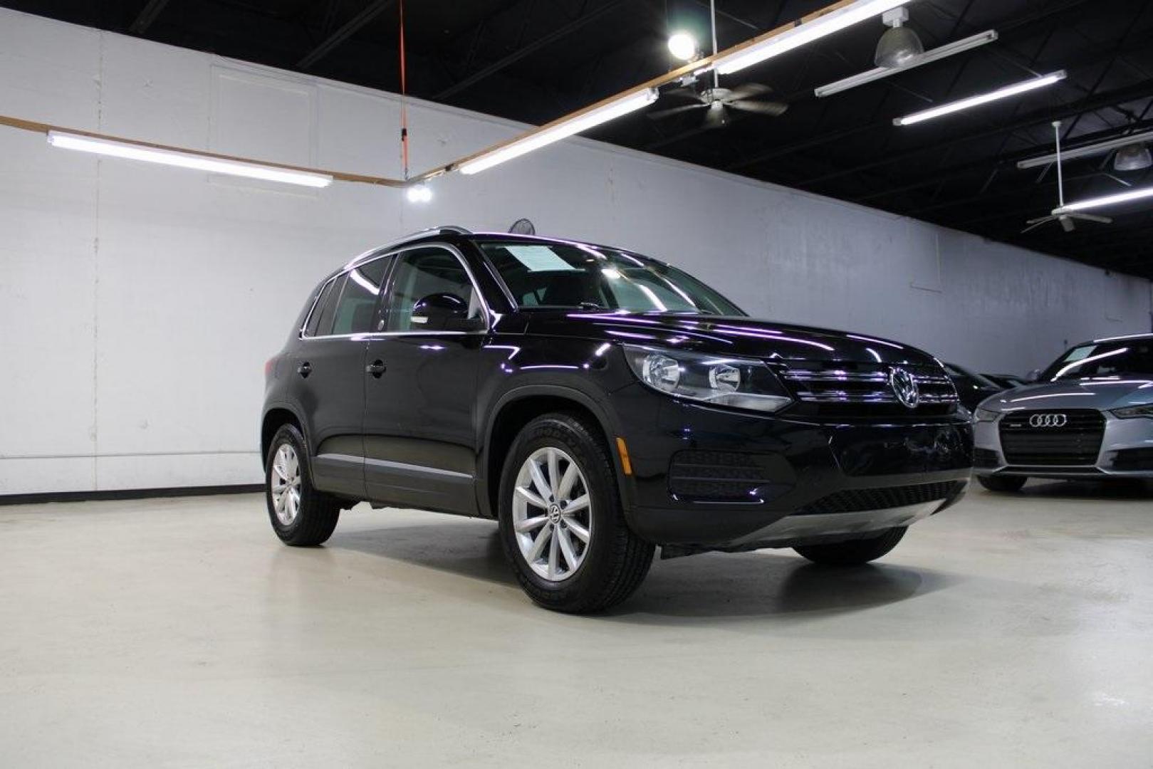 2017 Deep Black /Beige/Black Volkswagen Tiguan 2.0T Wolfsburg Edition (WVGRV7AX9HW) with an 2.0L TSI DOHC engine, Automatic transmission, located at 15300 Midway Rd., Addison, TX, 75001, (972) 702-0011, 32.958321, -96.838074 - Photo#1