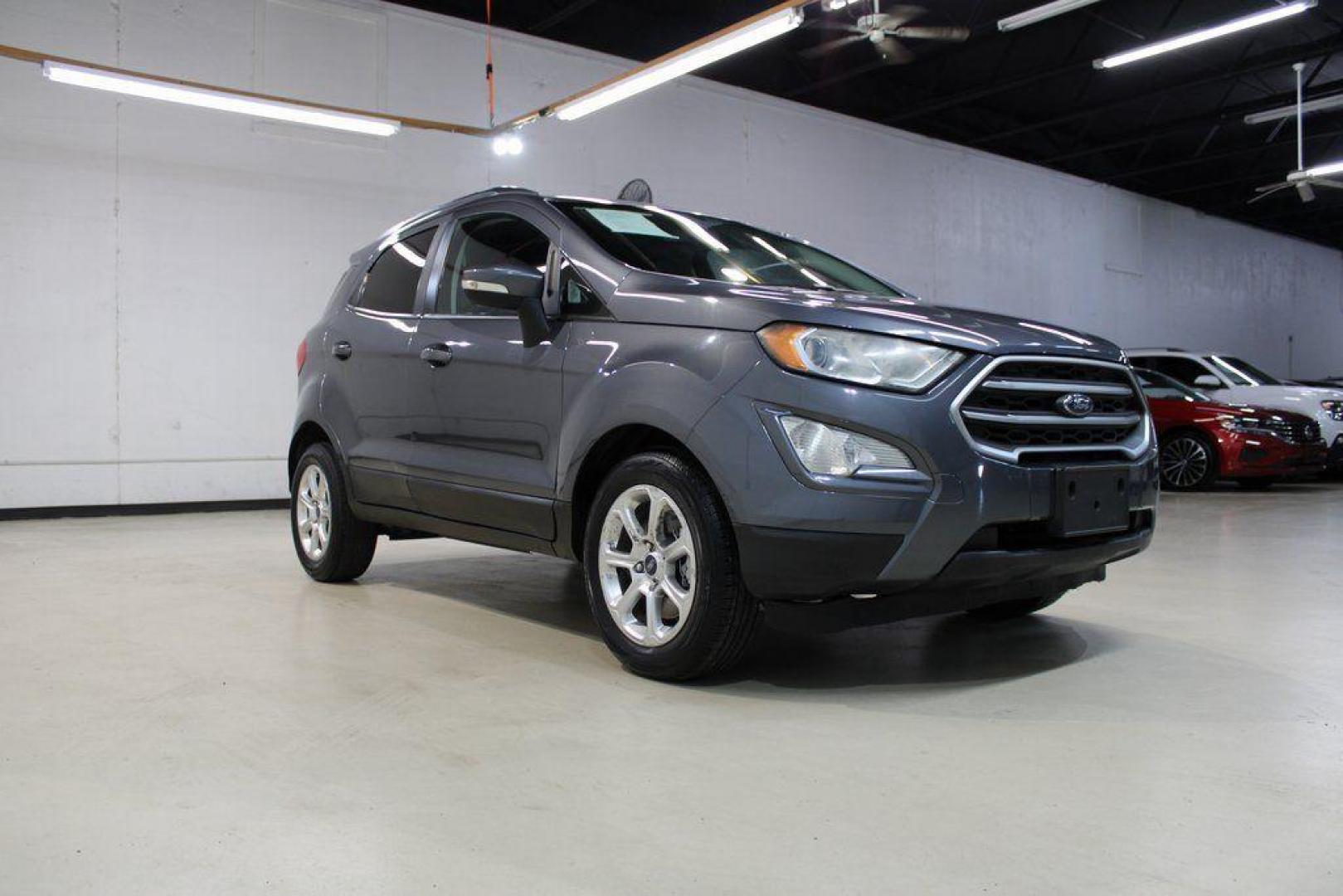 2019 Smoke /Ebony Black Ford EcoSport SE (MAJ3S2GE4KC) with an EcoBoost 1.0L I3 GTDi DOHC Turbocharged VCT engine, Automatic transmission, located at 15300 Midway Rd., Addison, TX, 75001, (972) 702-0011, 32.958321, -96.838074 - HOME OF THE NO HAGGLE PRICE - WHOLESALE PRICES TO THE PUBLIC!!<br><br>Smoke 2019 Ford EcoSport SE<br><br>27/29 City/Highway MPG<br><br><br>At Midway Auto Group, we strive to provide you with the best quality vehicles for the lowest possible price, and this 2019 Ford EcoSport is no exception,We finan - Photo#1