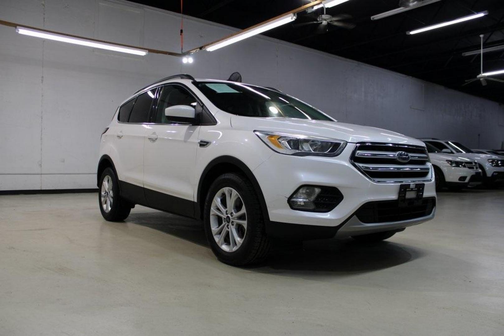 2018 White Platinum /Medium Light Stone Ford Escape SEL (1FMCU9HD7JU) with an 1.5L EcoBoost engine, Automatic transmission, located at 15300 Midway Rd., Addison, TX, 75001, (972) 702-0011, 32.958321, -96.838074 - Midway Auto Group in Addison, TX, is pleased to offer this 2018 Ford Escape SEL, a versatile and stylish SUV designed to meet your driving needs.<br><br>Key Features:<br><br>Engine and Performance: Powered by a 1.5L EcoBoost engine paired with an automatic transmission, delivering a balanced blend - Photo#1