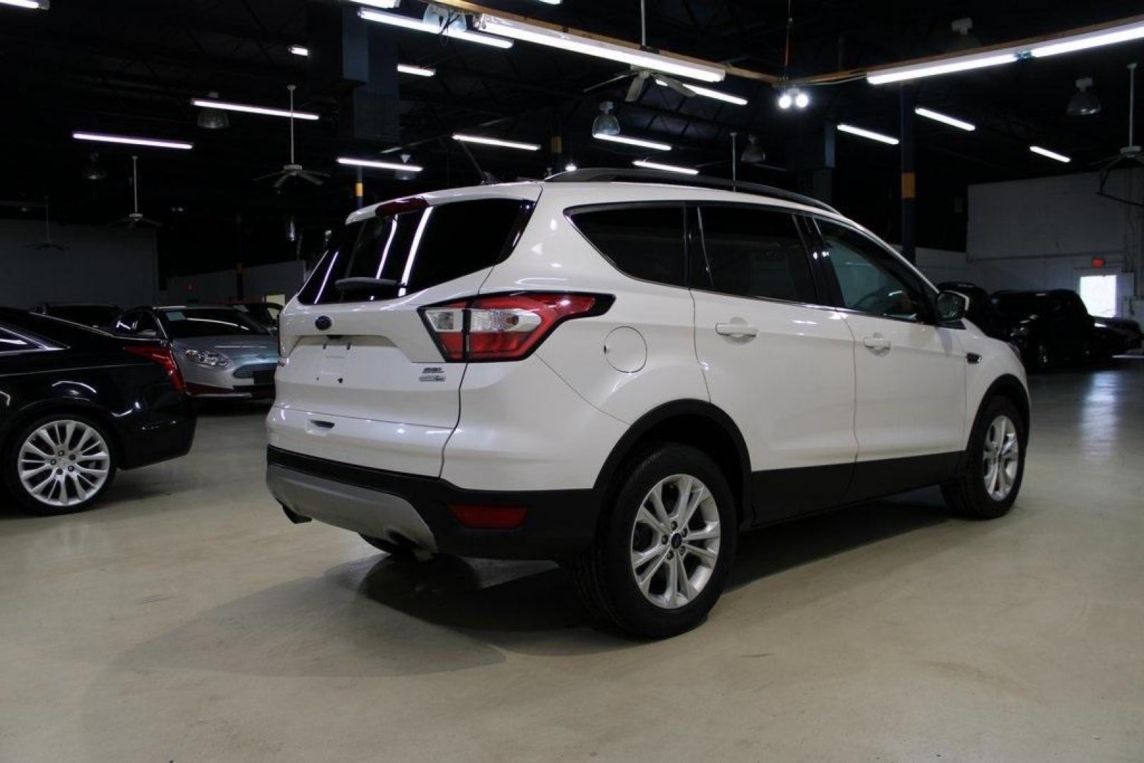 2018 White Platinum /Medium Light Stone Ford Escape SEL (1FMCU9HD7JU) with an 1.5L EcoBoost engine, Automatic transmission, located at 15300 Midway Rd., Addison, TX, 75001, (972) 702-0011, 32.958321, -96.838074 - Midway Auto Group in Addison, TX, is pleased to offer this 2018 Ford Escape SEL, a versatile and stylish SUV designed to meet your driving needs.<br><br>Key Features:<br><br>Engine and Performance: Powered by a 1.5L EcoBoost engine paired with an automatic transmission, delivering a balanced blend - Photo#2