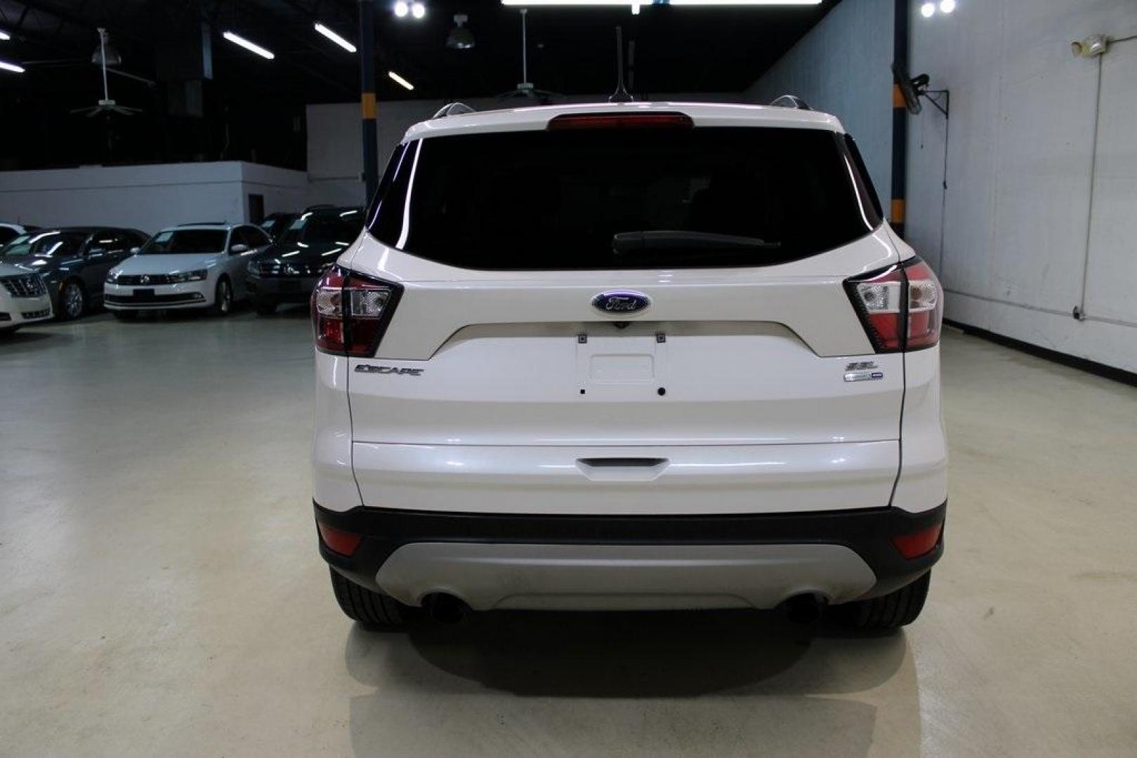 2018 White Platinum /Medium Light Stone Ford Escape SEL (1FMCU9HD7JU) with an 1.5L EcoBoost engine, Automatic transmission, located at 15300 Midway Rd., Addison, TX, 75001, (972) 702-0011, 32.958321, -96.838074 - Midway Auto Group in Addison, TX, is pleased to offer this 2018 Ford Escape SEL, a versatile and stylish SUV designed to meet your driving needs.<br><br>Key Features:<br><br>Engine and Performance: Powered by a 1.5L EcoBoost engine paired with an automatic transmission, delivering a balanced blend - Photo#7