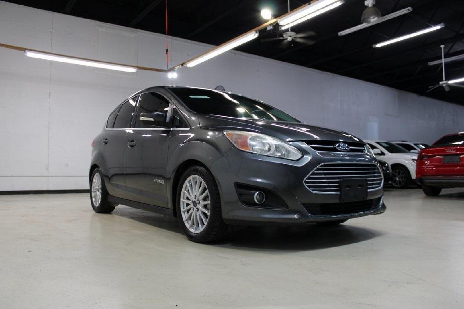 2015 Magnetic /Medium Light Stone Ford C-Max Hybrid SEL (1FADP5BU1FL) with an I4 Hybrid engine, CVT transmission, located at 15300 Midway Rd., Addison, TX, 75001, (972) 702-0011, 32.958321, -96.838074 - Midway Auto Group in Addison, TX, is pleased to offer this 2015 Ford C-Max SEL Hybrid, a versatile and fuel-efficient hatchback designed to enhance your driving experience. With 72,000 miles on the odometer, this well-maintained vehicle is available for $9,950. <br><br><br>Key Features:<br><br>Conve - Photo#1