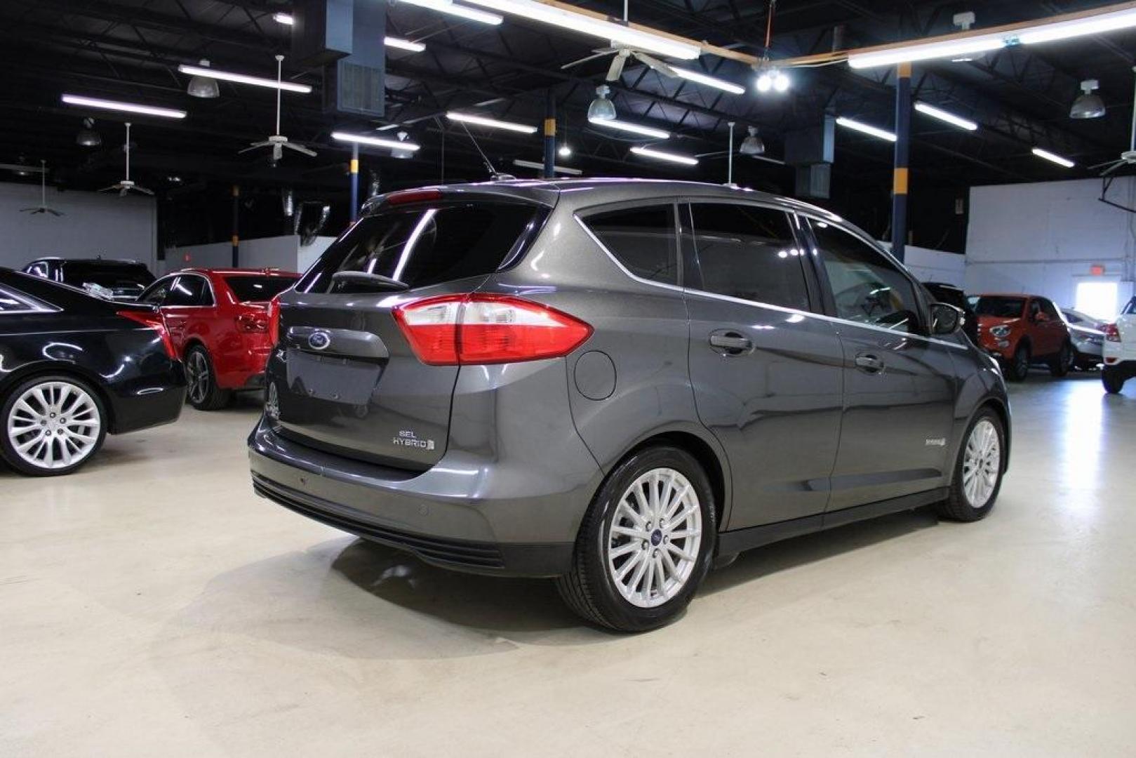 2015 Magnetic /Medium Light Stone Ford C-Max Hybrid SEL (1FADP5BU1FL) with an I4 Hybrid engine, CVT transmission, located at 15300 Midway Rd., Addison, TX, 75001, (972) 702-0011, 32.958321, -96.838074 - Midway Auto Group in Addison, TX, is pleased to offer this 2015 Ford C-Max SEL Hybrid, a versatile and fuel-efficient hatchback designed to enhance your driving experience. With 72,000 miles on the odometer, this well-maintained vehicle is available for $9,950. <br><br><br>Key Features:<br><br>Conve - Photo#2