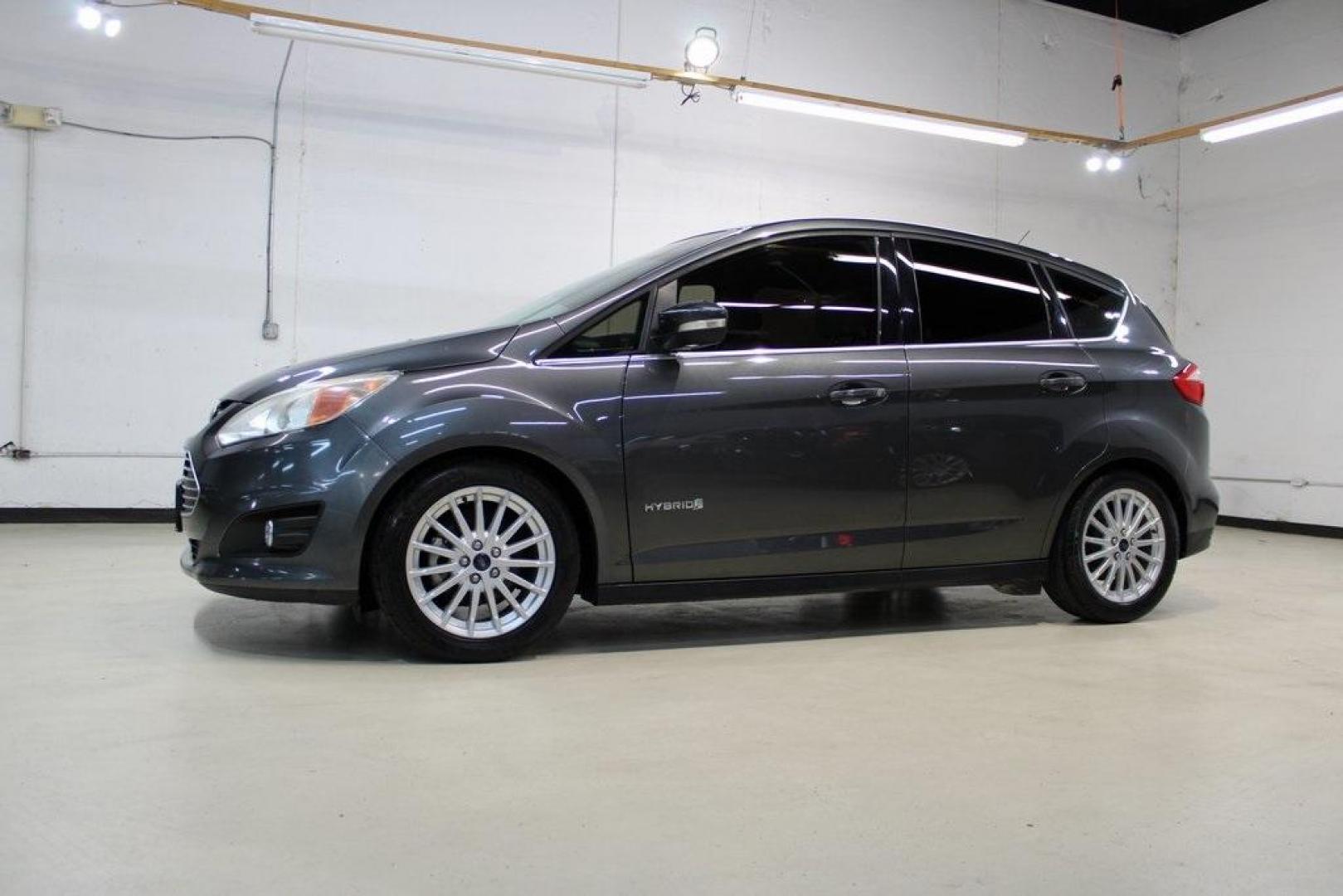2015 Magnetic /Medium Light Stone Ford C-Max Hybrid SEL (1FADP5BU1FL) with an I4 Hybrid engine, CVT transmission, located at 15300 Midway Rd., Addison, TX, 75001, (972) 702-0011, 32.958321, -96.838074 - Midway Auto Group in Addison, TX, is pleased to offer this 2015 Ford C-Max SEL Hybrid, a versatile and fuel-efficient hatchback designed to enhance your driving experience. With 72,000 miles on the odometer, this well-maintained vehicle is available for $9,950. <br><br><br>Key Features:<br><br>Conve - Photo#4