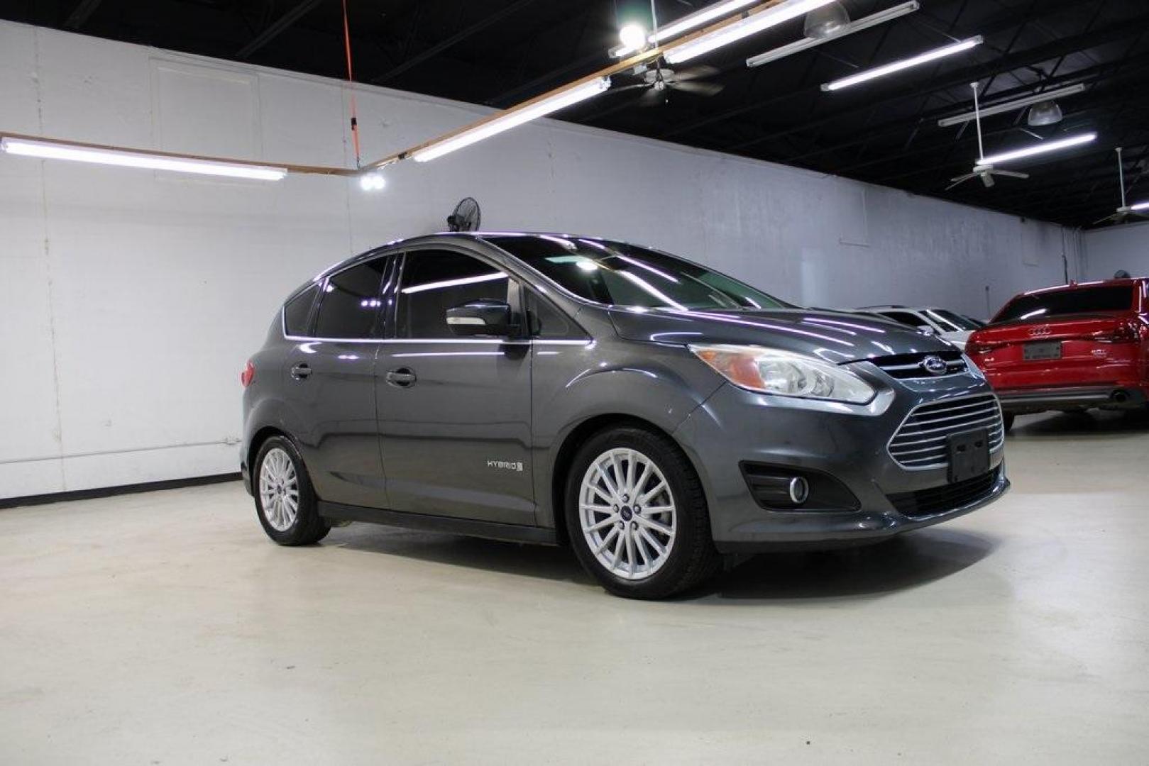 2015 Magnetic /Medium Light Stone Ford C-Max Hybrid SEL (1FADP5BU1FL) with an I4 Hybrid engine, CVT transmission, located at 15300 Midway Rd., Addison, TX, 75001, (972) 702-0011, 32.958321, -96.838074 - Midway Auto Group in Addison, TX, is pleased to offer this 2015 Ford C-Max SEL Hybrid, a versatile and fuel-efficient hatchback designed to enhance your driving experience. With 72,000 miles on the odometer, this well-maintained vehicle is available for $9,950. <br><br><br>Key Features:<br><br>Conve - Photo#6