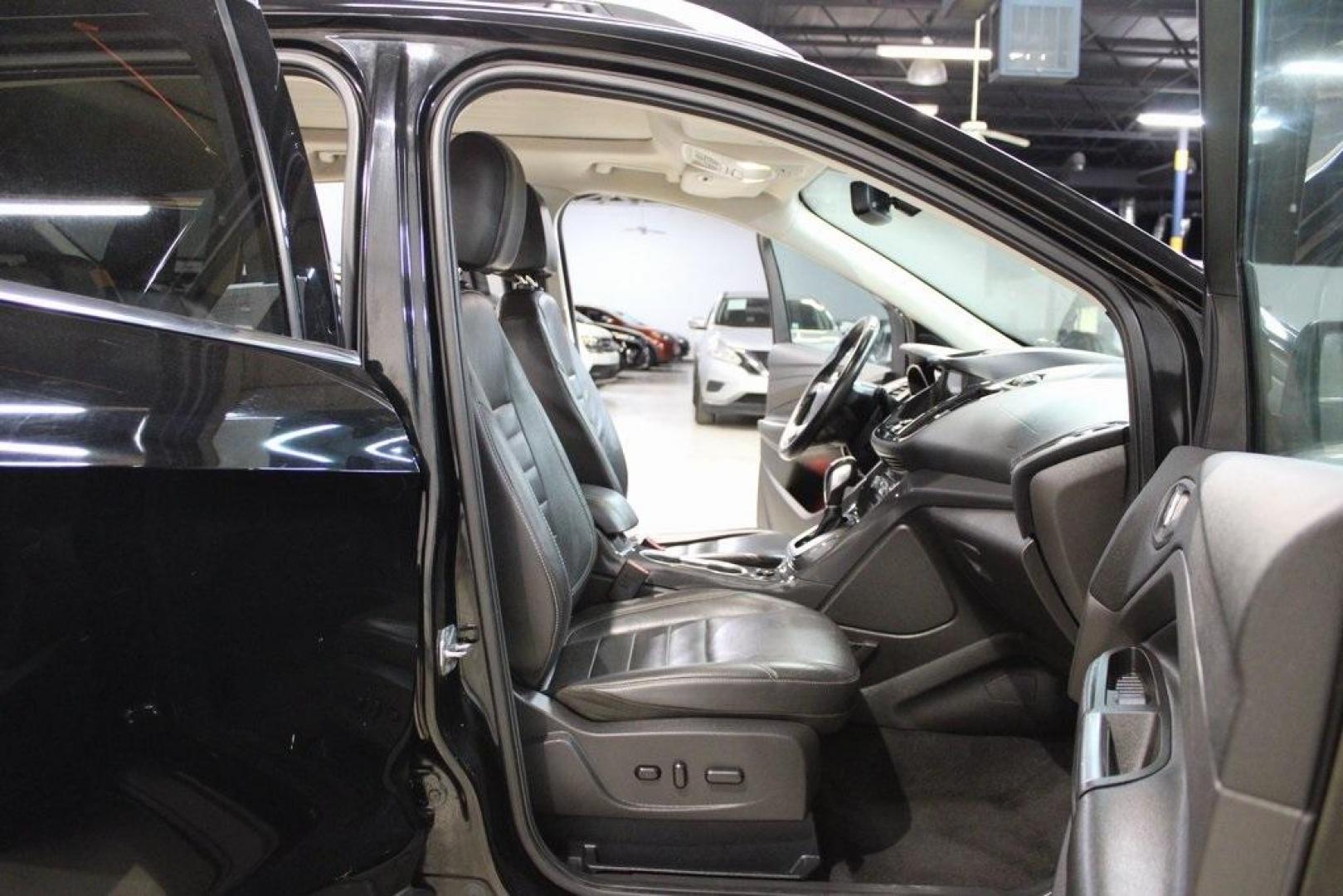 2016 Shadow Black /Black Ford Escape Titanium (1FMCU9J91GU) with an EcoBoost 2.0L I4 GTDi DOHC Turbocharged VCT engine, Automatic transmission, located at 15300 Midway Rd., Addison, TX, 75001, (972) 702-0011, 32.958321, -96.838074 - Introducing the 2016 Ford Escape Titanium, now available at Midway Auto Group in Addison, Texas. With 87,065 miles on the odometer and priced at $11,950, this SUV offers a blend of performance, comfort, and advanced features. <br>midwayautogroup.net<br>+2<br>midwayautogroup.net<br>+2<br>Cruz.com<br> - Photo#14