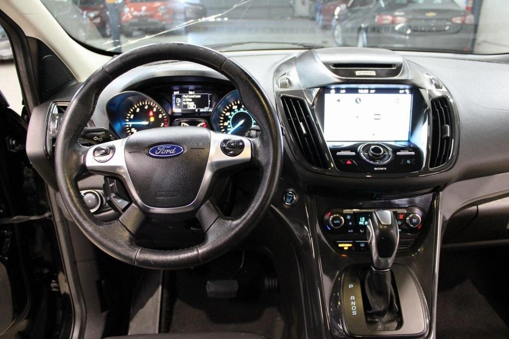 2016 Shadow Black /Black Ford Escape Titanium (1FMCU9J91GU) with an EcoBoost 2.0L I4 GTDi DOHC Turbocharged VCT engine, Automatic transmission, located at 15300 Midway Rd., Addison, TX, 75001, (972) 702-0011, 32.958321, -96.838074 - Introducing the 2016 Ford Escape Titanium, now available at Midway Auto Group in Addison, Texas. With 87,065 miles on the odometer and priced at $11,950, this SUV offers a blend of performance, comfort, and advanced features. <br>midwayautogroup.net<br>+2<br>midwayautogroup.net<br>+2<br>Cruz.com<br> - Photo#17