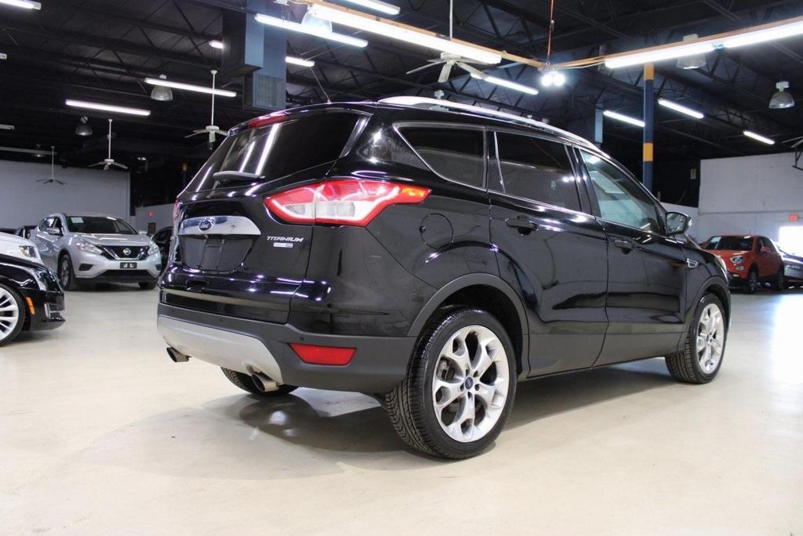 2016 Shadow Black /Black Ford Escape Titanium (1FMCU9J91GU) with an EcoBoost 2.0L I4 GTDi DOHC Turbocharged VCT engine, Automatic transmission, located at 15300 Midway Rd., Addison, TX, 75001, (972) 702-0011, 32.958321, -96.838074 - Introducing the 2016 Ford Escape Titanium, now available at Midway Auto Group in Addison, Texas. With 87,065 miles on the odometer and priced at $11,950, this SUV offers a blend of performance, comfort, and advanced features. <br>midwayautogroup.net<br>+2<br>midwayautogroup.net<br>+2<br>Cruz.com<br> - Photo#2