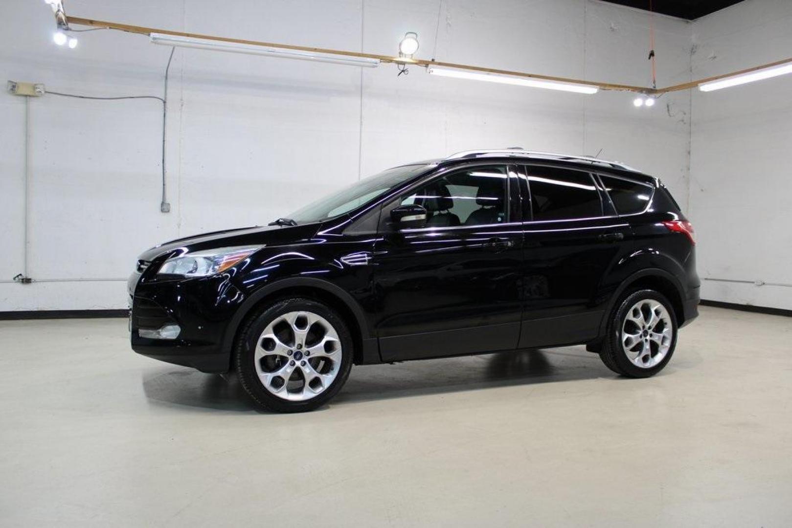 2016 Shadow Black /Black Ford Escape Titanium (1FMCU9J91GU) with an EcoBoost 2.0L I4 GTDi DOHC Turbocharged VCT engine, Automatic transmission, located at 15300 Midway Rd., Addison, TX, 75001, (972) 702-0011, 32.958321, -96.838074 - Introducing the 2016 Ford Escape Titanium, now available at Midway Auto Group in Addison, Texas. With 87,065 miles on the odometer and priced at $11,950, this SUV offers a blend of performance, comfort, and advanced features. <br>midwayautogroup.net<br>+2<br>midwayautogroup.net<br>+2<br>Cruz.com<br> - Photo#4