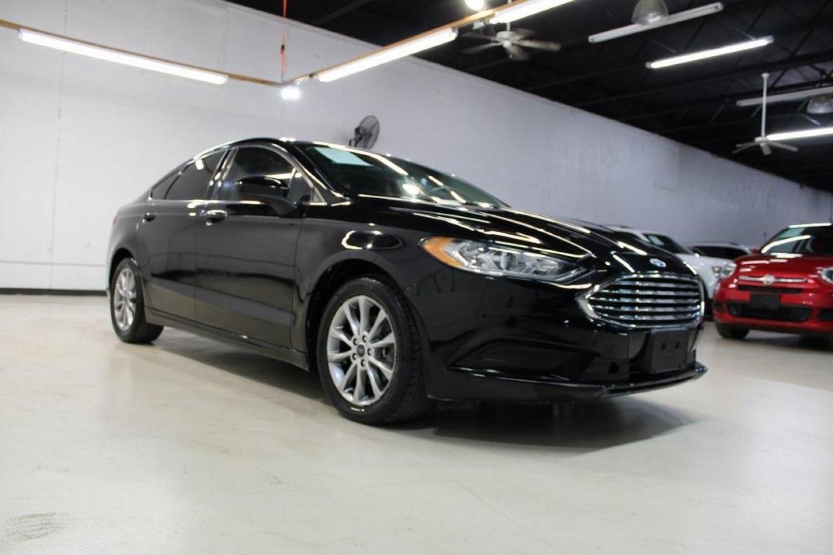 2017 Shadow Black /Ebony Ford Fusion SE (3FA6P0HD6HR) with an 1.5L EcoBoost engine, Automatic transmission, located at 15300 Midway Rd., Addison, TX, 75001, (972) 702-0011, 32.958321, -96.838074 - Stylish, spacious, and built for the road ahead, the 2017 Ford Fusion SE delivers a perfect balance of performance, technology, and comfort. With its sleek design and turbocharged efficiency, this midsize sedan is an outstanding value for anyone looking for a reliable daily driver or a comfortable h - Photo#1