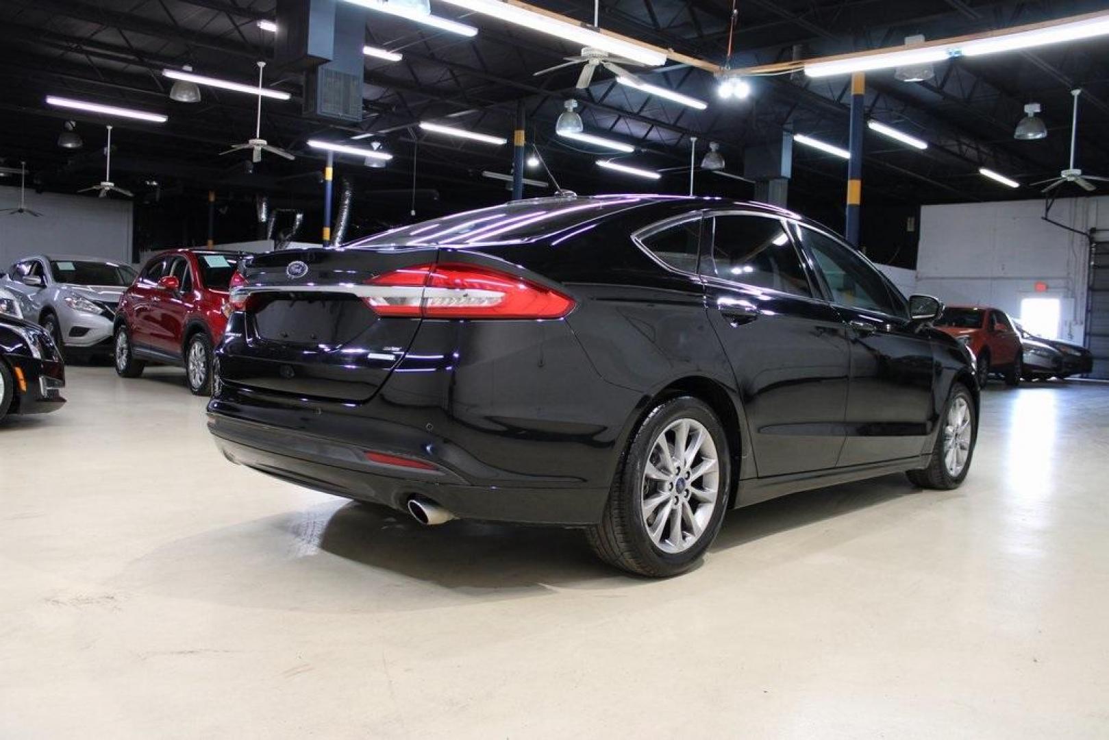2017 Shadow Black /Ebony Ford Fusion SE (3FA6P0HD6HR) with an 1.5L EcoBoost engine, Automatic transmission, located at 15300 Midway Rd., Addison, TX, 75001, (972) 702-0011, 32.958321, -96.838074 - Stylish, spacious, and built for the road ahead, the 2017 Ford Fusion SE delivers a perfect balance of performance, technology, and comfort. With its sleek design and turbocharged efficiency, this midsize sedan is an outstanding value for anyone looking for a reliable daily driver or a comfortable h - Photo#2
