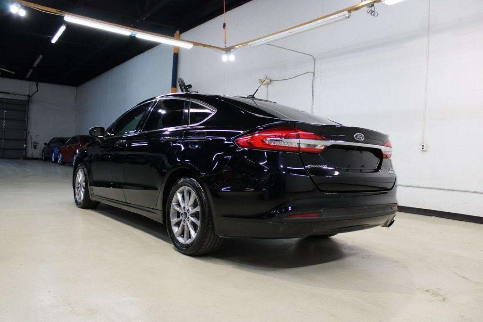2017 Shadow Black /Ebony Ford Fusion SE (3FA6P0HD6HR) with an 1.5L EcoBoost engine, Automatic transmission, located at 15300 Midway Rd., Addison, TX, 75001, (972) 702-0011, 32.958321, -96.838074 - Stylish, spacious, and built for the road ahead, the 2017 Ford Fusion SE delivers a perfect balance of performance, technology, and comfort. With its sleek design and turbocharged efficiency, this midsize sedan is an outstanding value for anyone looking for a reliable daily driver or a comfortable h - Photo#3