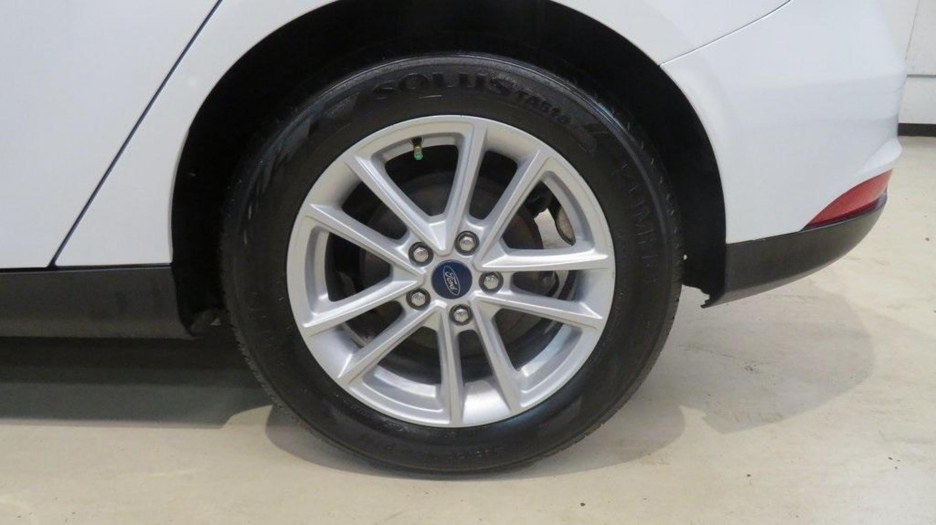 2017 Oxford White /Charcoal Black Ford Focus SE (1FADP3K2XHL) with an 2.0L 4-Cylinder DGI Flex Fuel DOHC engine, Automatic transmission, located at 15300 Midway Rd., Addison, TX, 75001, (972) 702-0011, 32.958321, -96.838074 - Introducing the 2017 Ford Focus SE Hatchback, now available at Midway Auto Group in Addison, Texas. This versatile and stylish compact car is designed to meet the needs of both city driving and weekend adventures.<br><br>Key Features:<br><br>Engine: 2.0L Ti-VCT I-4<br><br>Transmission: 6-speed autom - Photo#9
