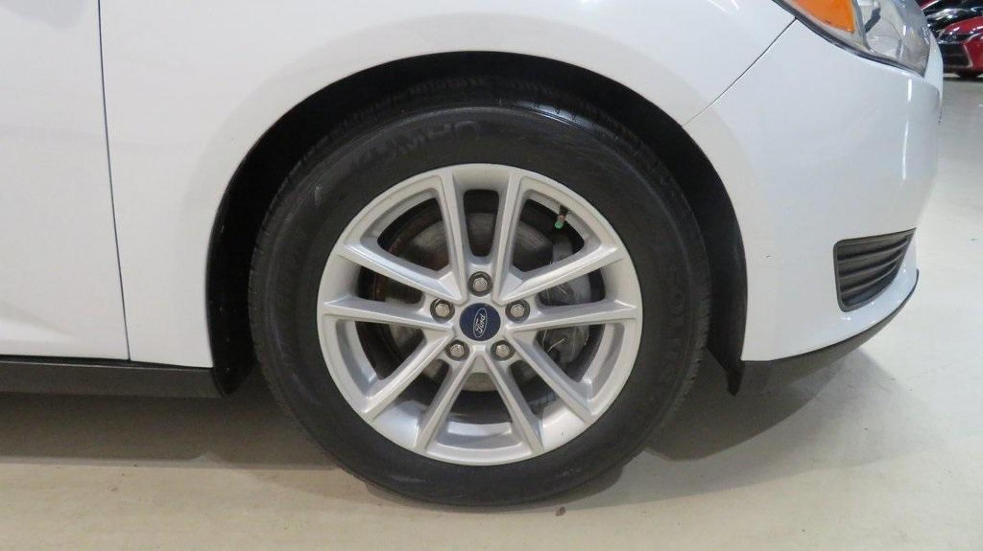 2017 Oxford White /Charcoal Black Ford Focus SE (1FADP3K2XHL) with an 2.0L 4-Cylinder DGI Flex Fuel DOHC engine, Automatic transmission, located at 15300 Midway Rd., Addison, TX, 75001, (972) 702-0011, 32.958321, -96.838074 - Introducing the 2017 Ford Focus SE Hatchback, now available at Midway Auto Group in Addison, Texas. This versatile and stylish compact car is designed to meet the needs of both city driving and weekend adventures.<br><br>Key Features:<br><br>Engine: 2.0L Ti-VCT I-4<br><br>Transmission: 6-speed autom - Photo#11