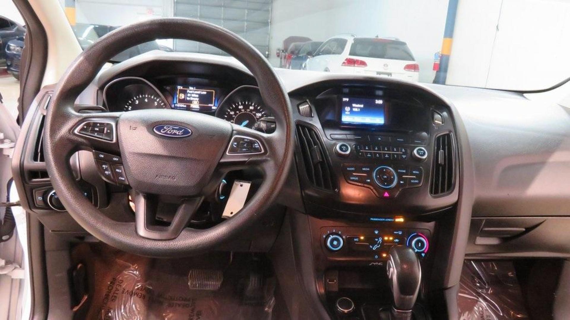2017 Oxford White /Charcoal Black Ford Focus SE (1FADP3K2XHL) with an 2.0L 4-Cylinder DGI Flex Fuel DOHC engine, Automatic transmission, located at 15300 Midway Rd., Addison, TX, 75001, (972) 702-0011, 32.958321, -96.838074 - Introducing the 2017 Ford Focus SE Hatchback, now available at Midway Auto Group in Addison, Texas. This versatile and stylish compact car is designed to meet the needs of both city driving and weekend adventures.<br><br>Key Features:<br><br>Engine: 2.0L Ti-VCT I-4<br><br>Transmission: 6-speed autom - Photo#14