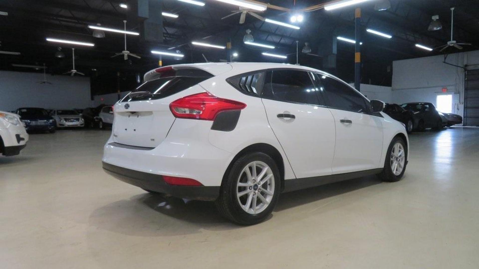 2017 Oxford White /Charcoal Black Ford Focus SE (1FADP3K2XHL) with an 2.0L 4-Cylinder DGI Flex Fuel DOHC engine, Automatic transmission, located at 15300 Midway Rd., Addison, TX, 75001, (972) 702-0011, 32.958321, -96.838074 - Introducing the 2017 Ford Focus SE Hatchback, now available at Midway Auto Group in Addison, Texas. This versatile and stylish compact car is designed to meet the needs of both city driving and weekend adventures.<br><br>Key Features:<br><br>Engine: 2.0L Ti-VCT I-4<br><br>Transmission: 6-speed autom - Photo#2