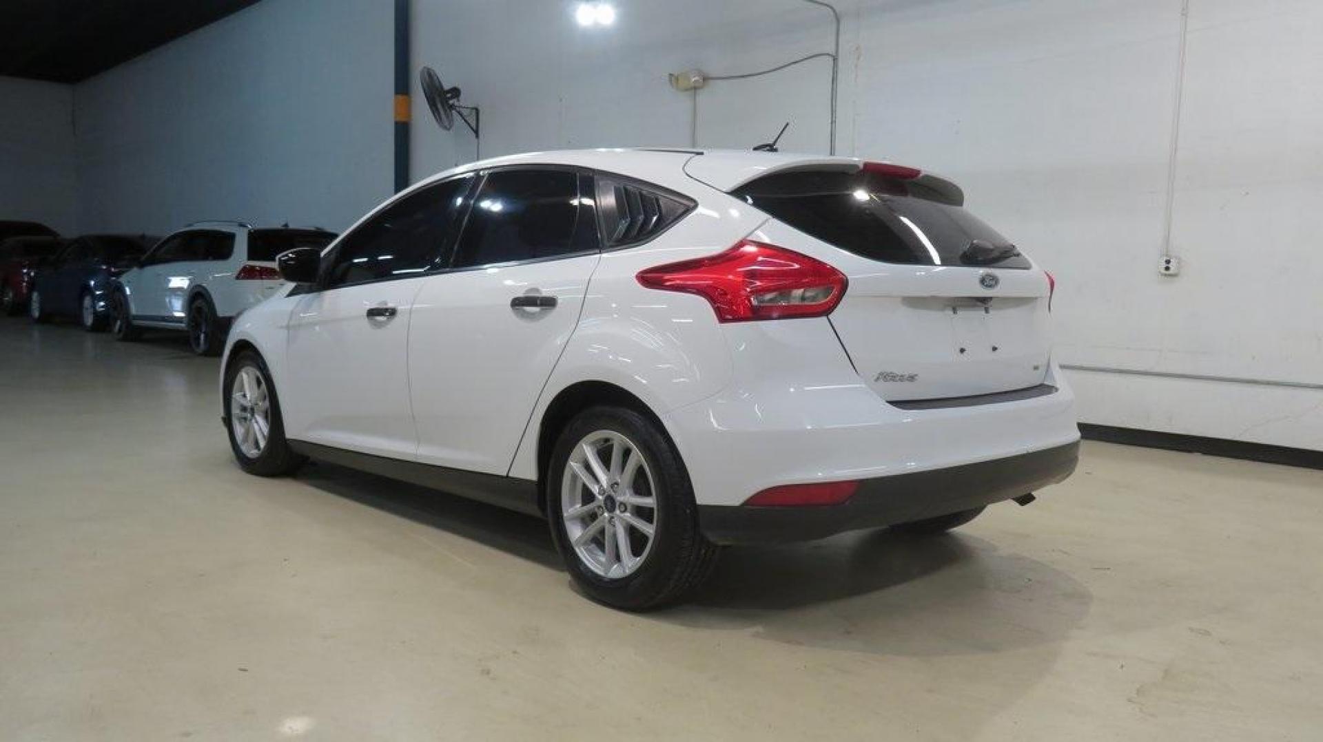 2017 Oxford White /Charcoal Black Ford Focus SE (1FADP3K2XHL) with an 2.0L 4-Cylinder DGI Flex Fuel DOHC engine, Automatic transmission, located at 15300 Midway Rd., Addison, TX, 75001, (972) 702-0011, 32.958321, -96.838074 - Introducing the 2017 Ford Focus SE Hatchback, now available at Midway Auto Group in Addison, Texas. This versatile and stylish compact car is designed to meet the needs of both city driving and weekend adventures.<br><br>Key Features:<br><br>Engine: 2.0L Ti-VCT I-4<br><br>Transmission: 6-speed autom - Photo#3