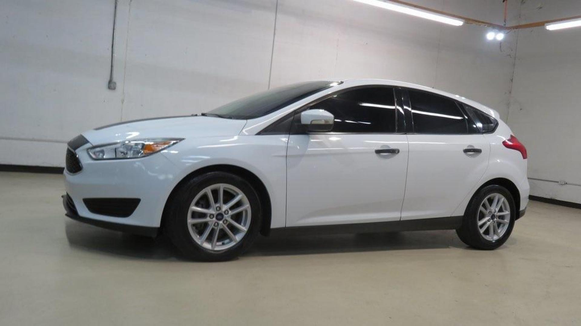2017 Oxford White /Charcoal Black Ford Focus SE (1FADP3K2XHL) with an 2.0L 4-Cylinder DGI Flex Fuel DOHC engine, Automatic transmission, located at 15300 Midway Rd., Addison, TX, 75001, (972) 702-0011, 32.958321, -96.838074 - Introducing the 2017 Ford Focus SE Hatchback, now available at Midway Auto Group in Addison, Texas. This versatile and stylish compact car is designed to meet the needs of both city driving and weekend adventures.<br><br>Key Features:<br><br>Engine: 2.0L Ti-VCT I-4<br><br>Transmission: 6-speed autom - Photo#4