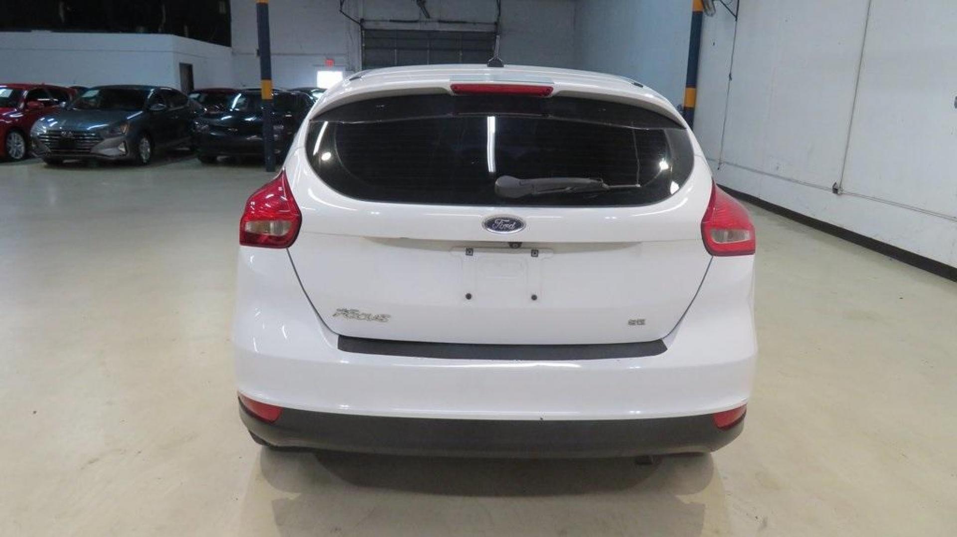 2017 Oxford White /Charcoal Black Ford Focus SE (1FADP3K2XHL) with an 2.0L 4-Cylinder DGI Flex Fuel DOHC engine, Automatic transmission, located at 15300 Midway Rd., Addison, TX, 75001, (972) 702-0011, 32.958321, -96.838074 - Introducing the 2017 Ford Focus SE Hatchback, now available at Midway Auto Group in Addison, Texas. This versatile and stylish compact car is designed to meet the needs of both city driving and weekend adventures.<br><br>Key Features:<br><br>Engine: 2.0L Ti-VCT I-4<br><br>Transmission: 6-speed autom - Photo#7