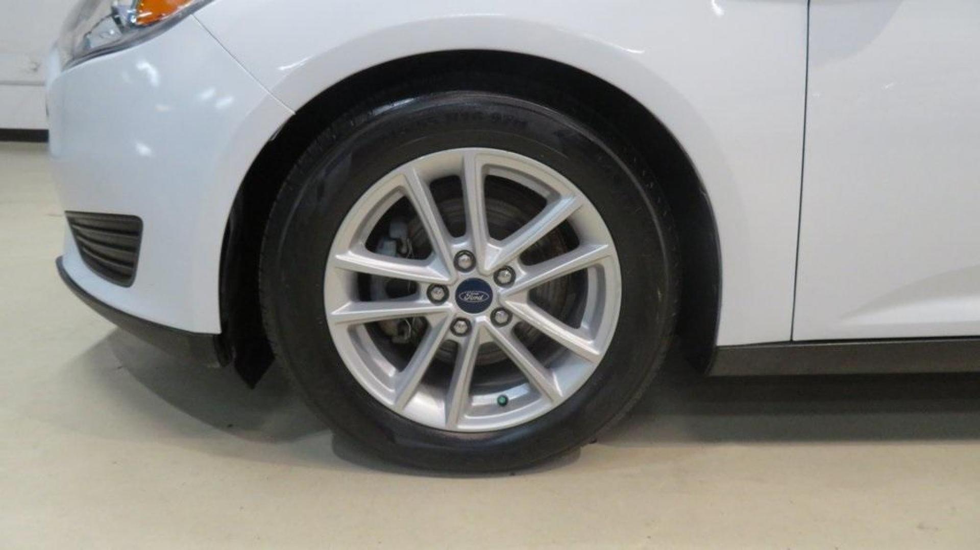 2017 Oxford White /Charcoal Black Ford Focus SE (1FADP3K2XHL) with an 2.0L 4-Cylinder DGI Flex Fuel DOHC engine, Automatic transmission, located at 15300 Midway Rd., Addison, TX, 75001, (972) 702-0011, 32.958321, -96.838074 - Introducing the 2017 Ford Focus SE Hatchback, now available at Midway Auto Group in Addison, Texas. This versatile and stylish compact car is designed to meet the needs of both city driving and weekend adventures.<br><br>Key Features:<br><br>Engine: 2.0L Ti-VCT I-4<br><br>Transmission: 6-speed autom - Photo#8