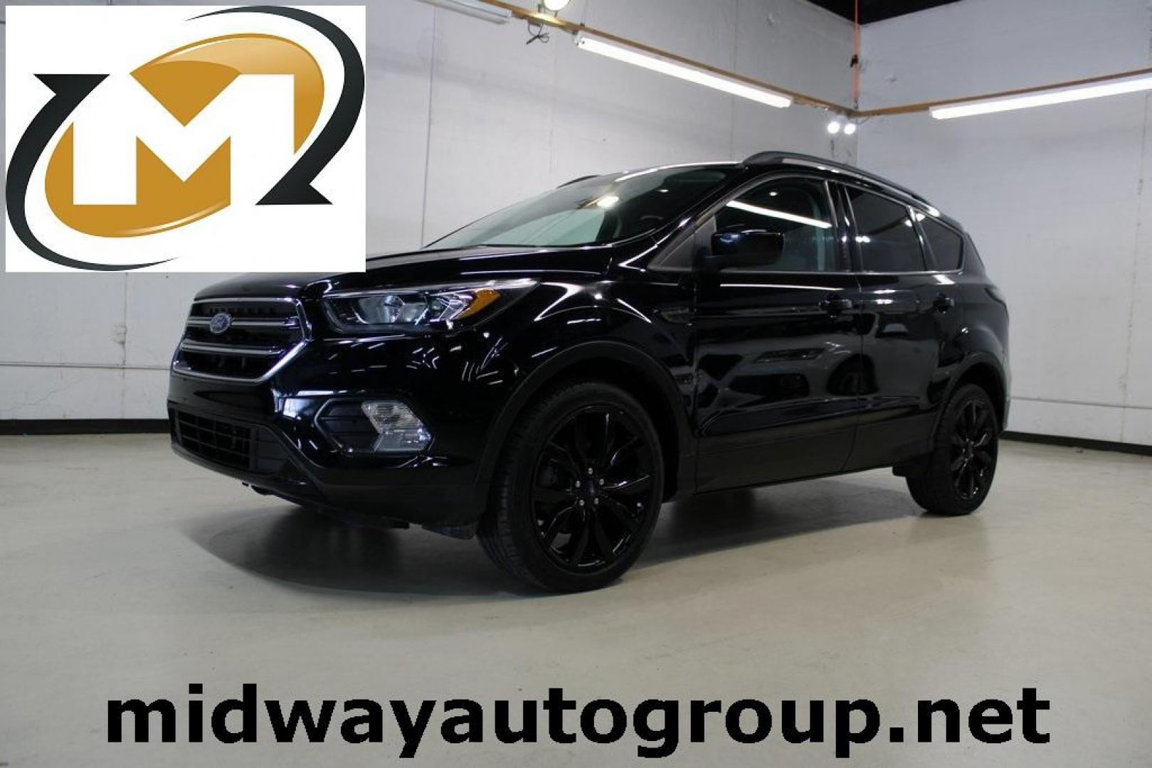 2018 Shadow Black /Charcoal Black Ford Escape SE (1FMCU0GD6JU) with an EcoBoost 2.0L I4 GTDi DOHC Turbocharged VCT engine, Automatic transmission, located at 15300 Midway Rd., Addison, TX, 75001, (972) 702-0011, 32.958321, -96.838074 - 2018 Ford Escape SE<br>Now Available at Midway Auto Group Addison, Texas<br><br>Well-rounded, efficient, and built for everyday versatility, the 2018 Ford Escape SE is the compact SUV that adapts to your lifestyle. With its turbocharged power, smooth ride, and smart interior layout, the Escape is i - Photo#0
