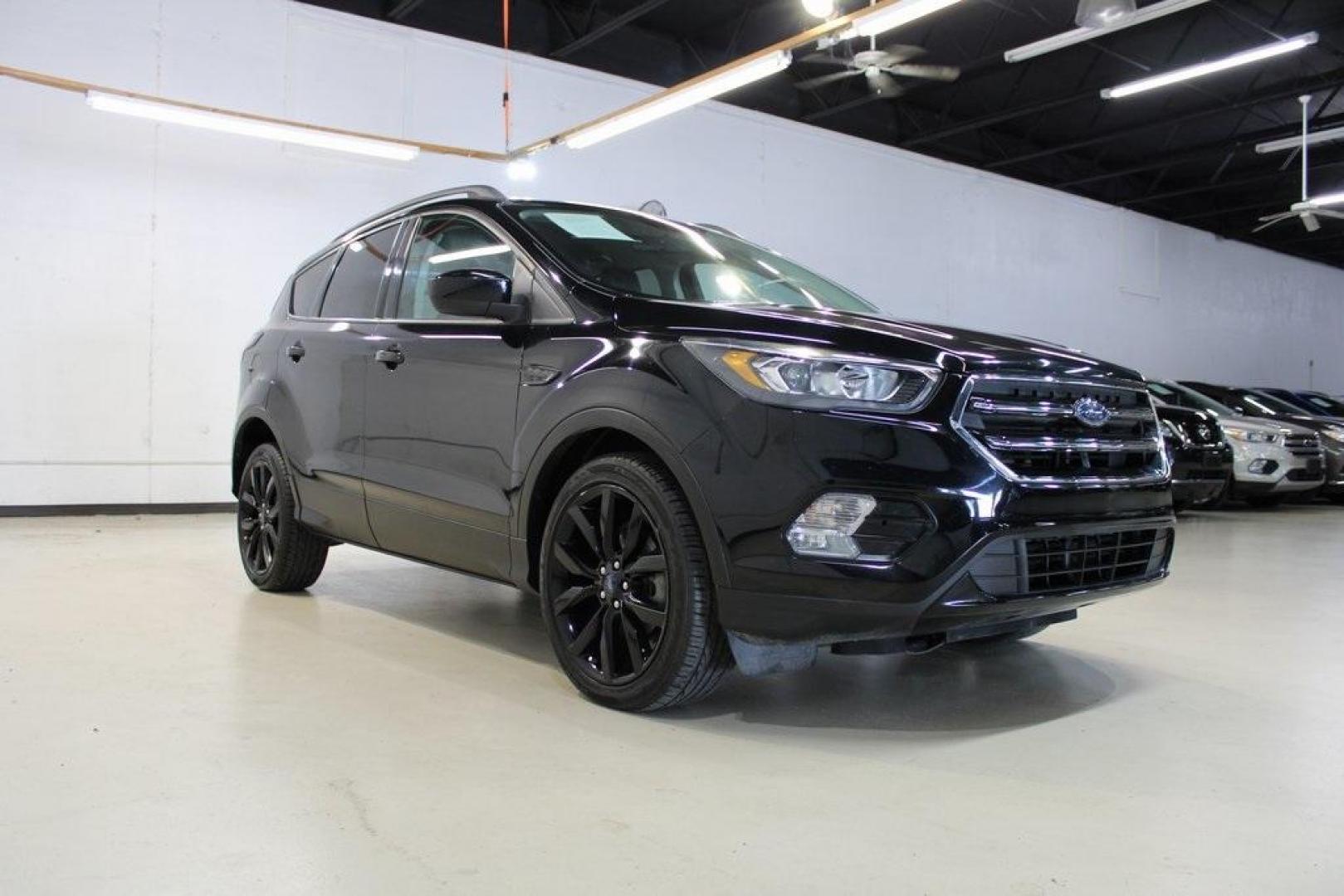 2018 Shadow Black /Charcoal Black Ford Escape SE (1FMCU0GD6JU) with an EcoBoost 2.0L I4 GTDi DOHC Turbocharged VCT engine, Automatic transmission, located at 15300 Midway Rd., Addison, TX, 75001, (972) 702-0011, 32.958321, -96.838074 - 2018 Ford Escape SE<br>Now Available at Midway Auto Group Addison, Texas<br><br>Well-rounded, efficient, and built for everyday versatility, the 2018 Ford Escape SE is the compact SUV that adapts to your lifestyle. With its turbocharged power, smooth ride, and smart interior layout, the Escape is i - Photo#1